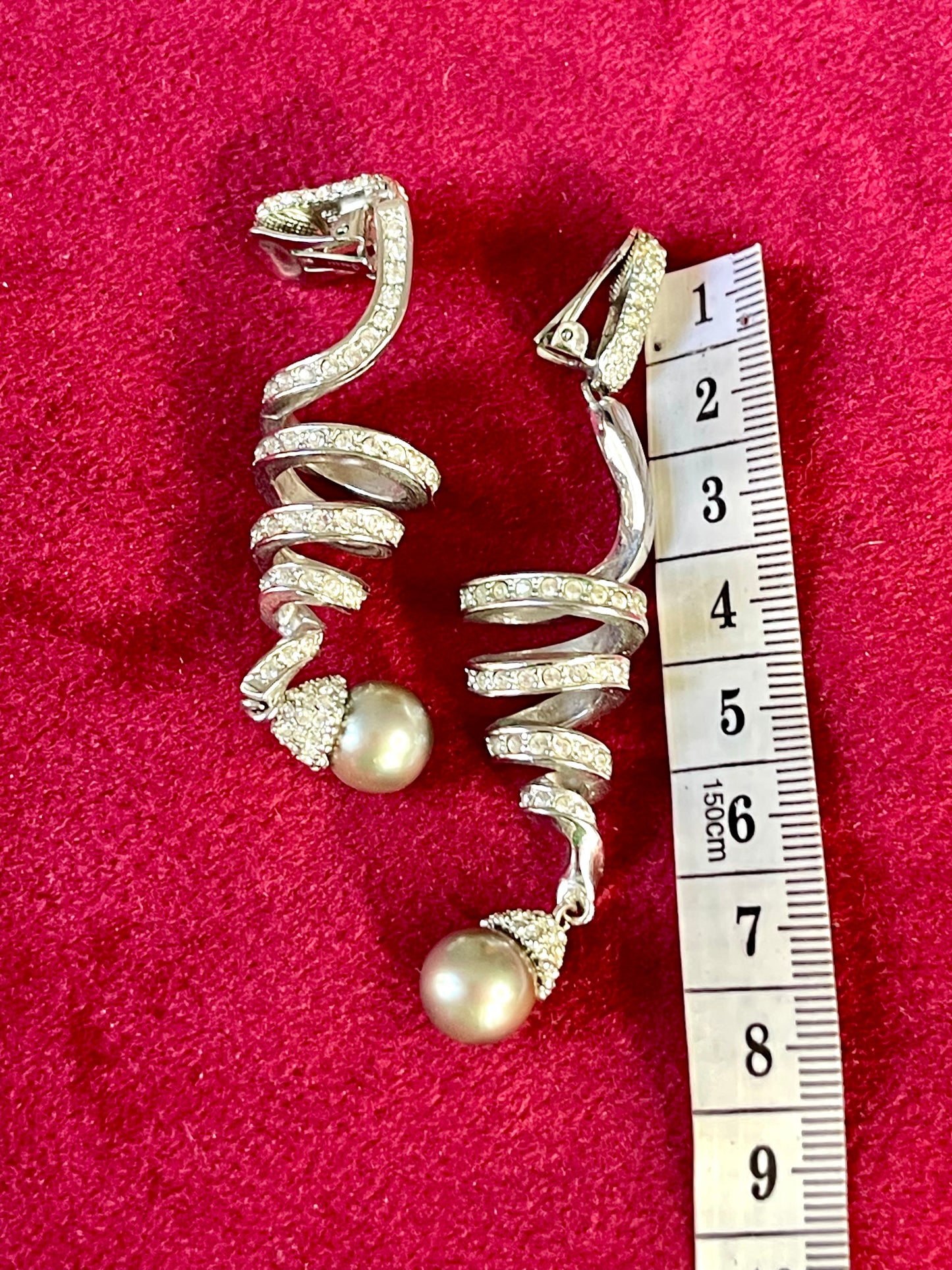 Measurement of a Pair of Dior Grossé rhinestone and pearl drop earrings placed side by side on red background