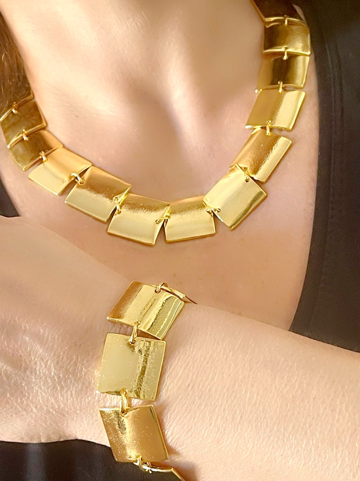 Close up of Iconic Paco Rabanne vintage gold plated jewelry set , bracelet- necklace refurbished 18KG worn on model