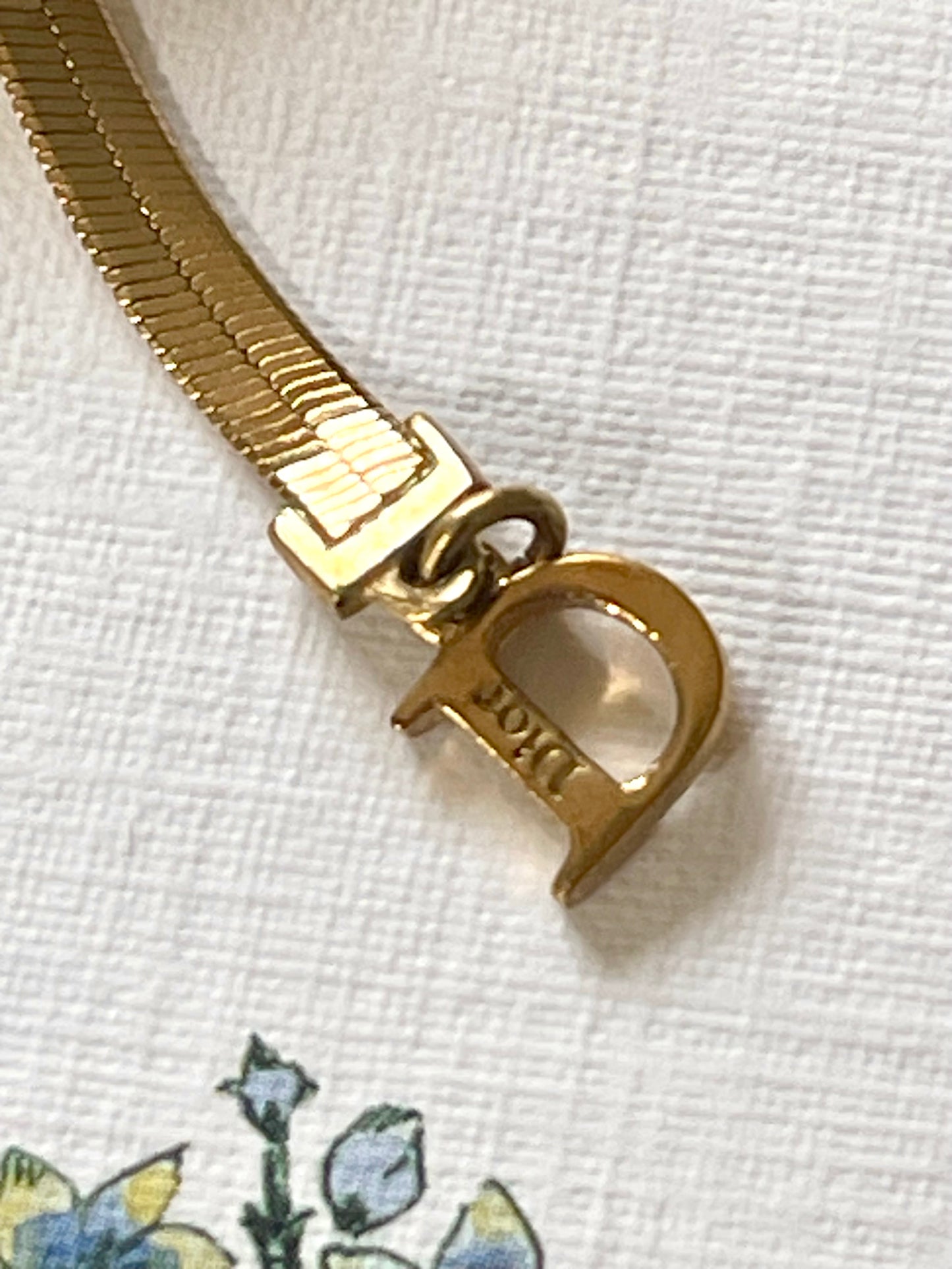 Close up in hallmark Dior Gold ribbon CD charms red elastic bracelet adjustable size