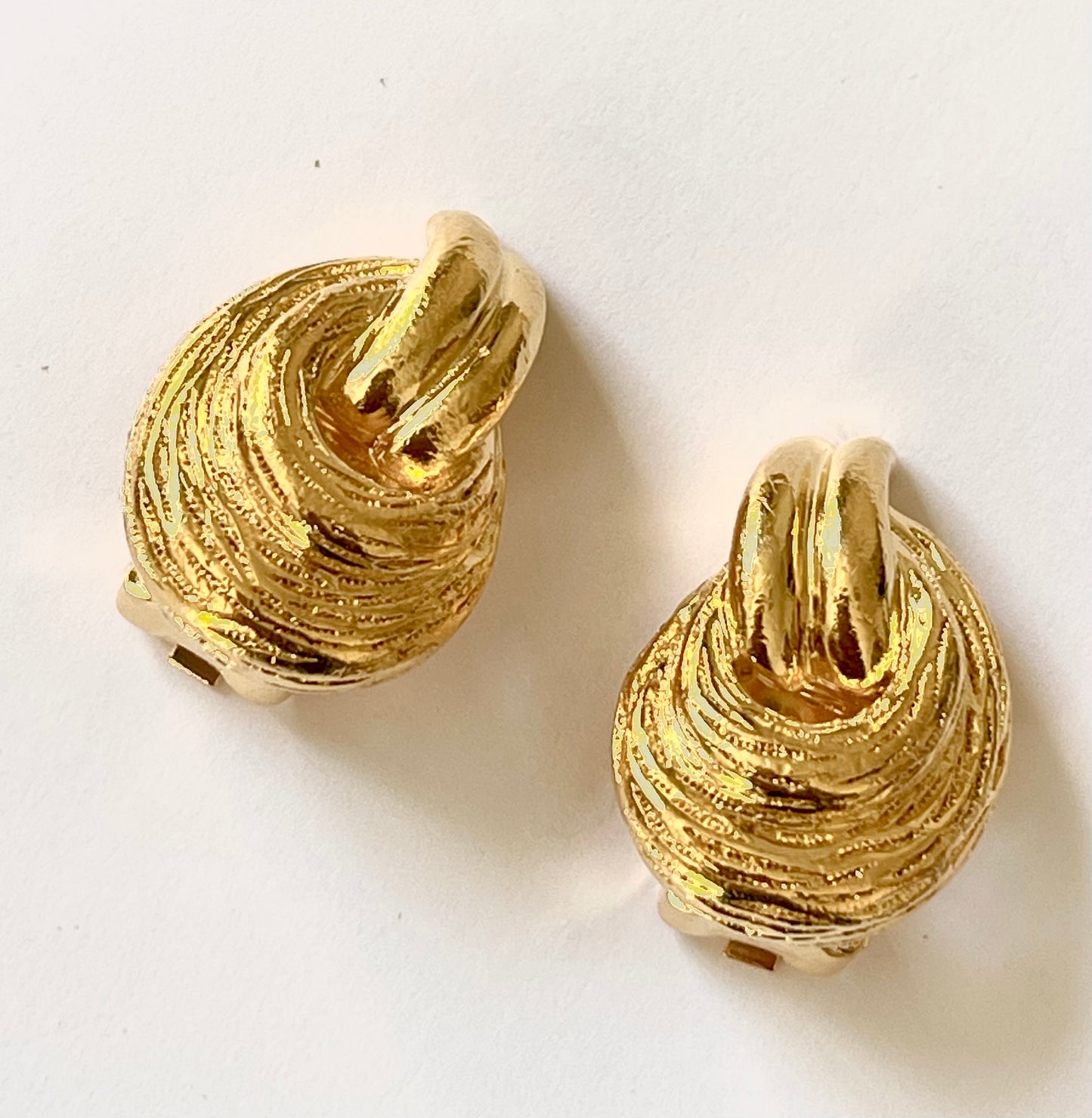 Vintage Christian Dior clip on Dior earrings, gold plated 18KG displayed on a white background