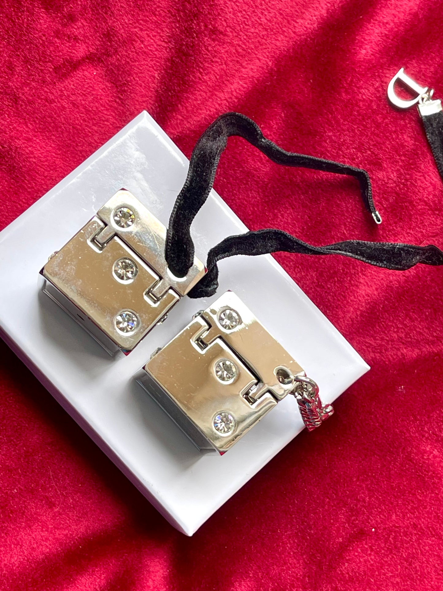 Close-up of hinge and clasp mechanism of Dior Play dice charm rare collector item bag charm vintage 2000