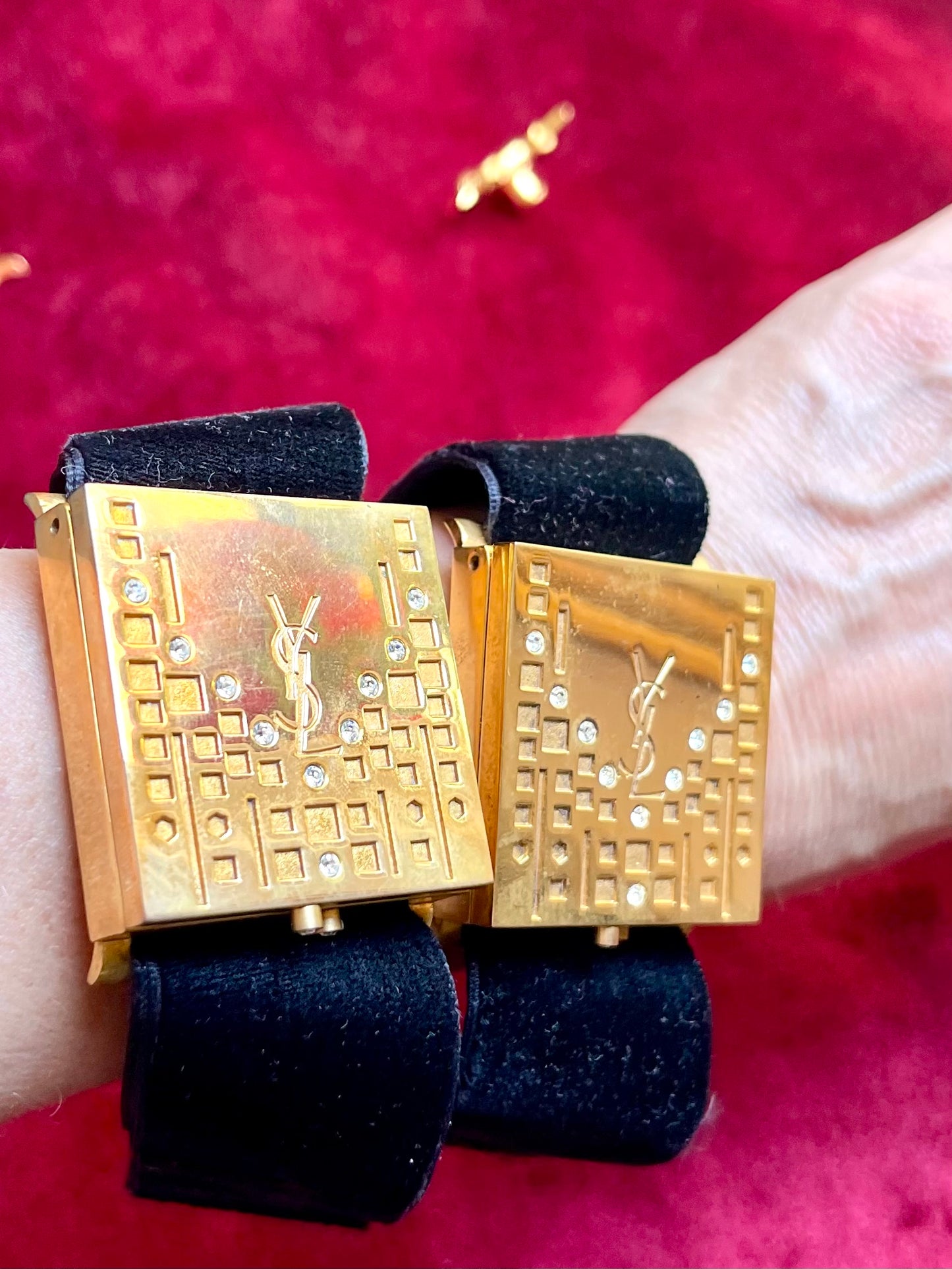 Worn by model two Fashion Bracelet makeup Yves Saint Laurent vintage 2000 displayed with YSL pins on a red velvet background