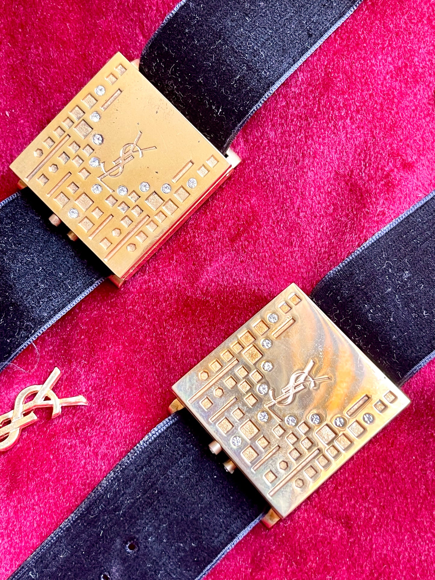 Top view Fashion Bracelet makeup Yves Saint Laurent vintage 2000 displayed with YSL pins on a red velvet background