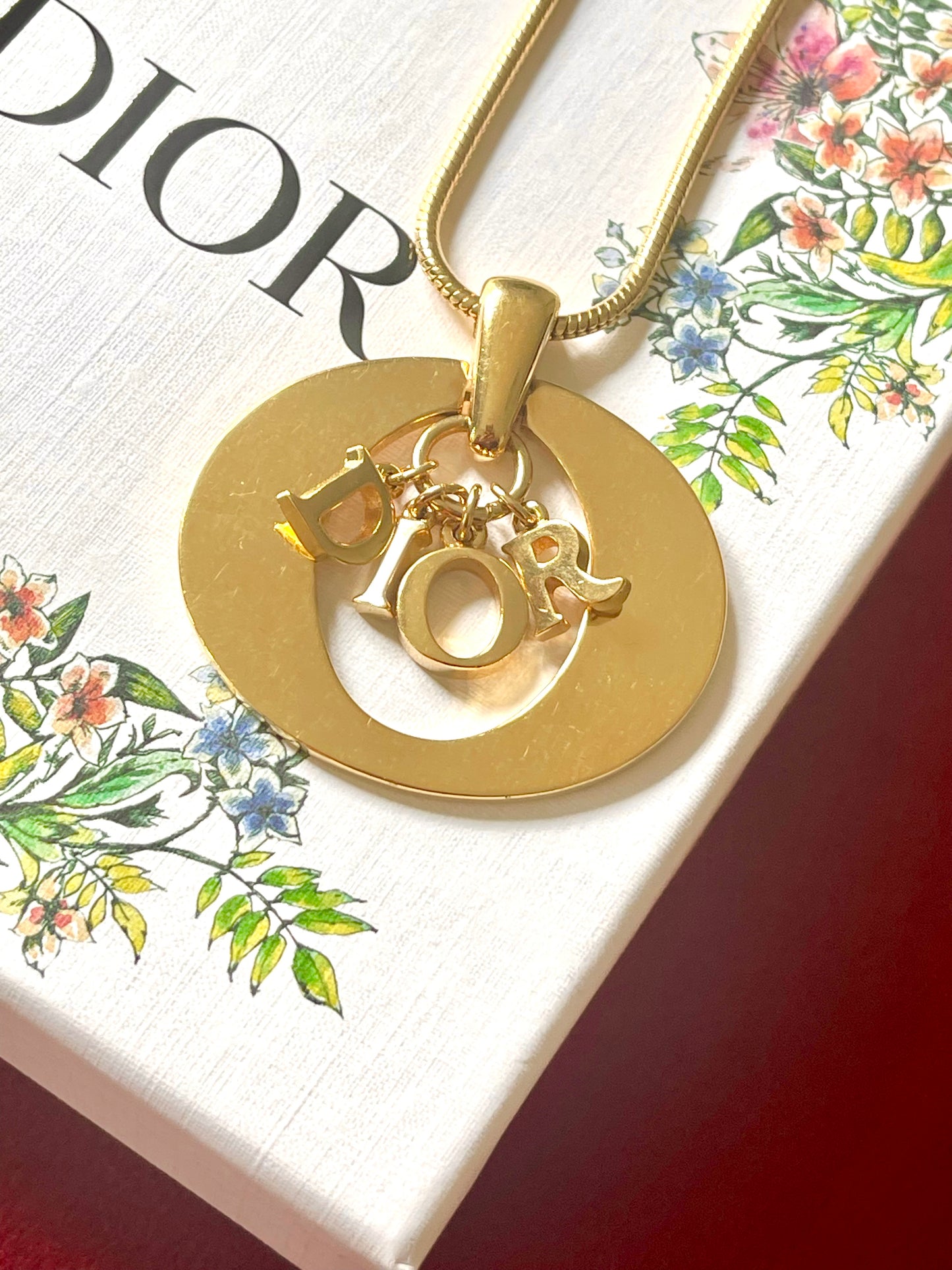 Authentic vintage Christian Dior necklace featuring a bold gold-tone pendant with iconic DIOR letter charms. Circa late 1990s–early 2000s. Chain length approx46 cm