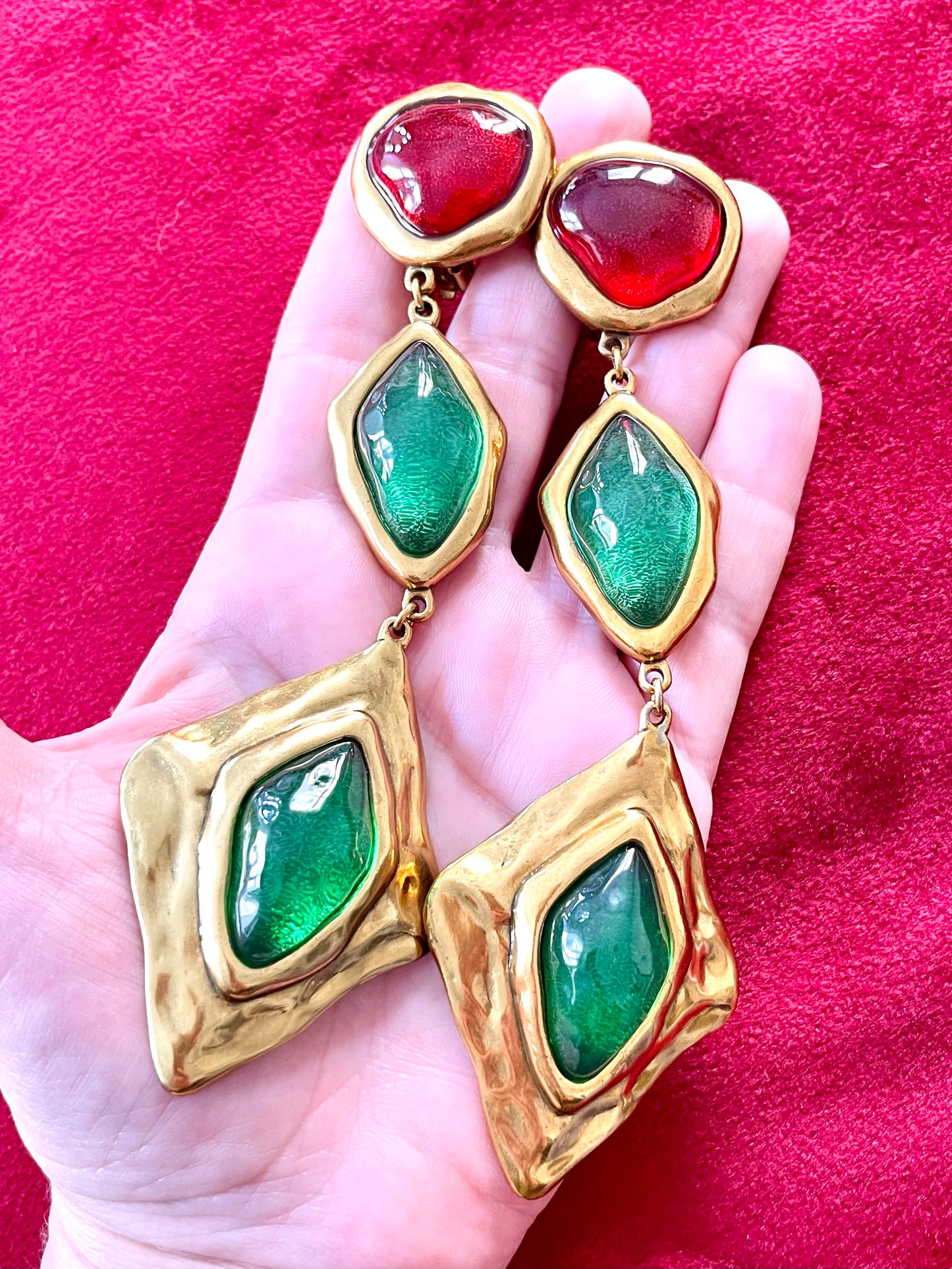 On hand showing the statement
Yves Saint Laurent XXL Vintage design inspired green red stones copper metal