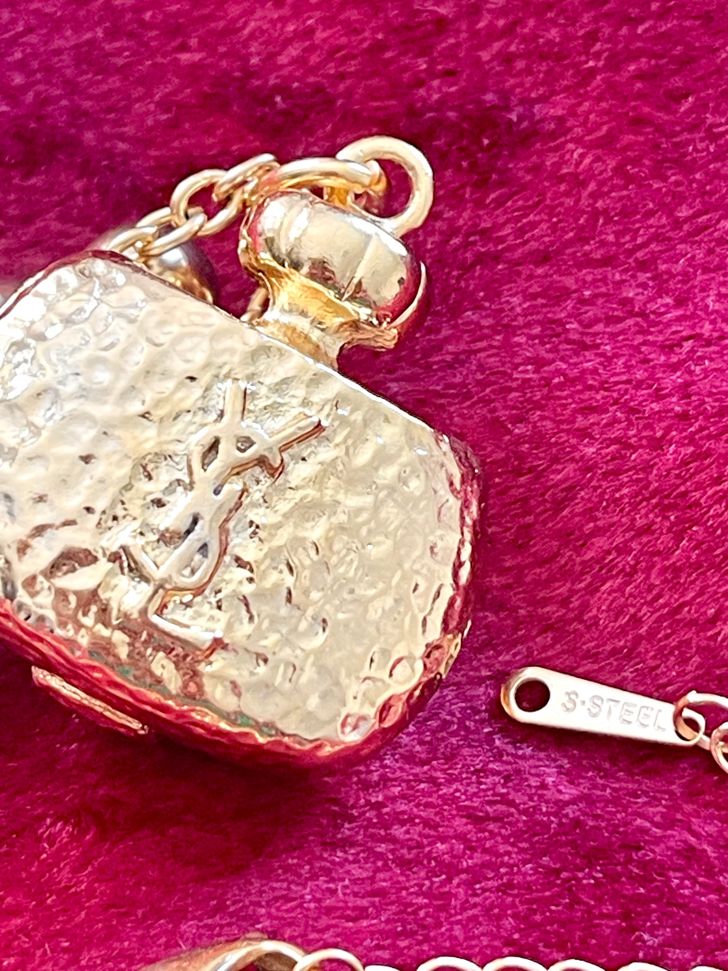 Close up signed YSL Yves Saint Laurent gold plated authentic collectors pendant, vintage 80s miniature perfume bottle Champagne