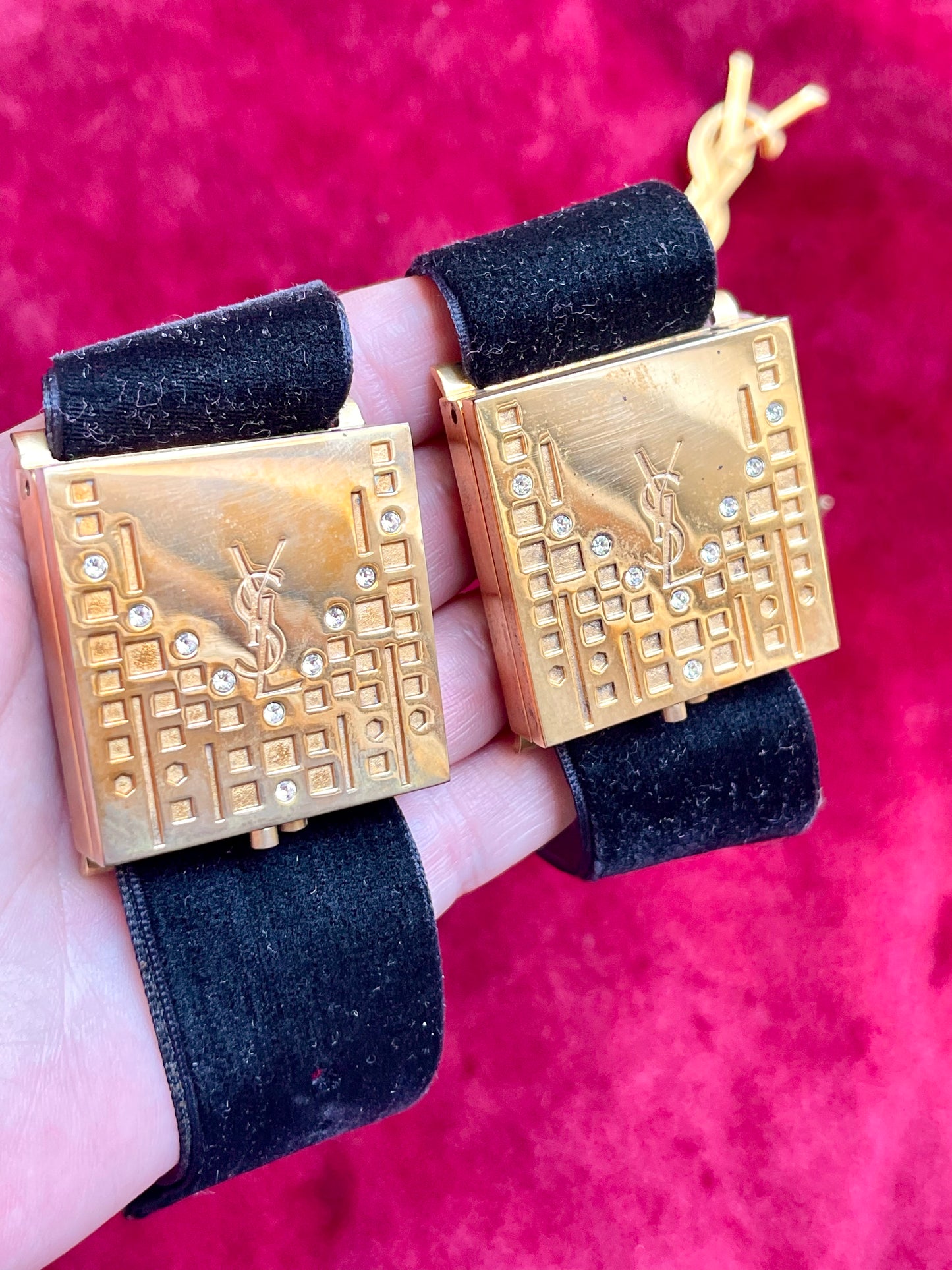 On hand Two Fashion Bracelet makeup Yves Saint Laurent vintage 2000 displayed with YSL pins on a red velvet background