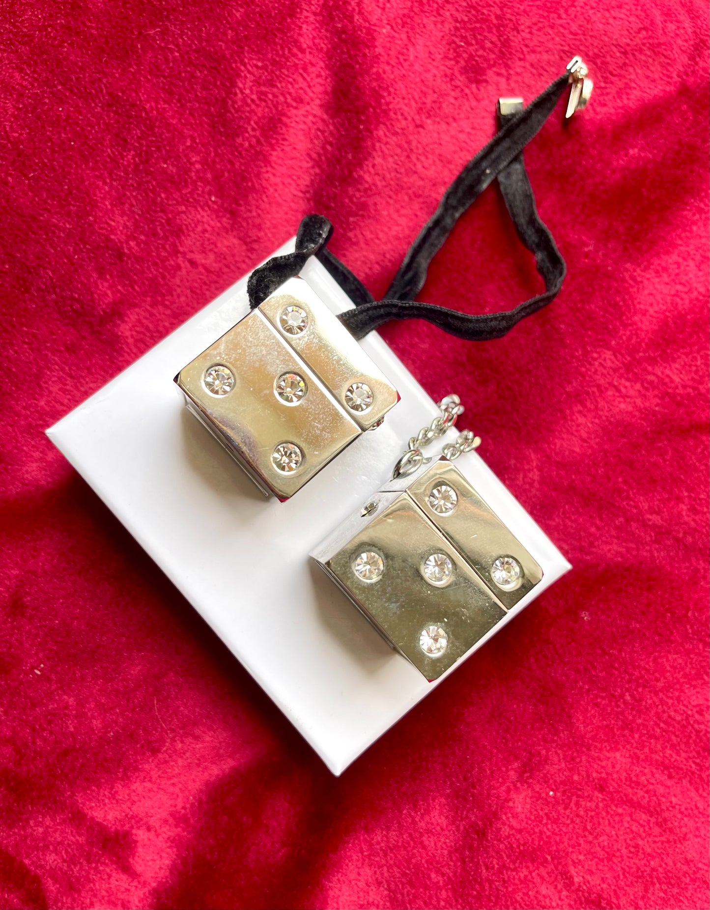Side view of vintage Dior Play dice-shaped bag charm with silver finish and embedded crystals vintage collection 2000