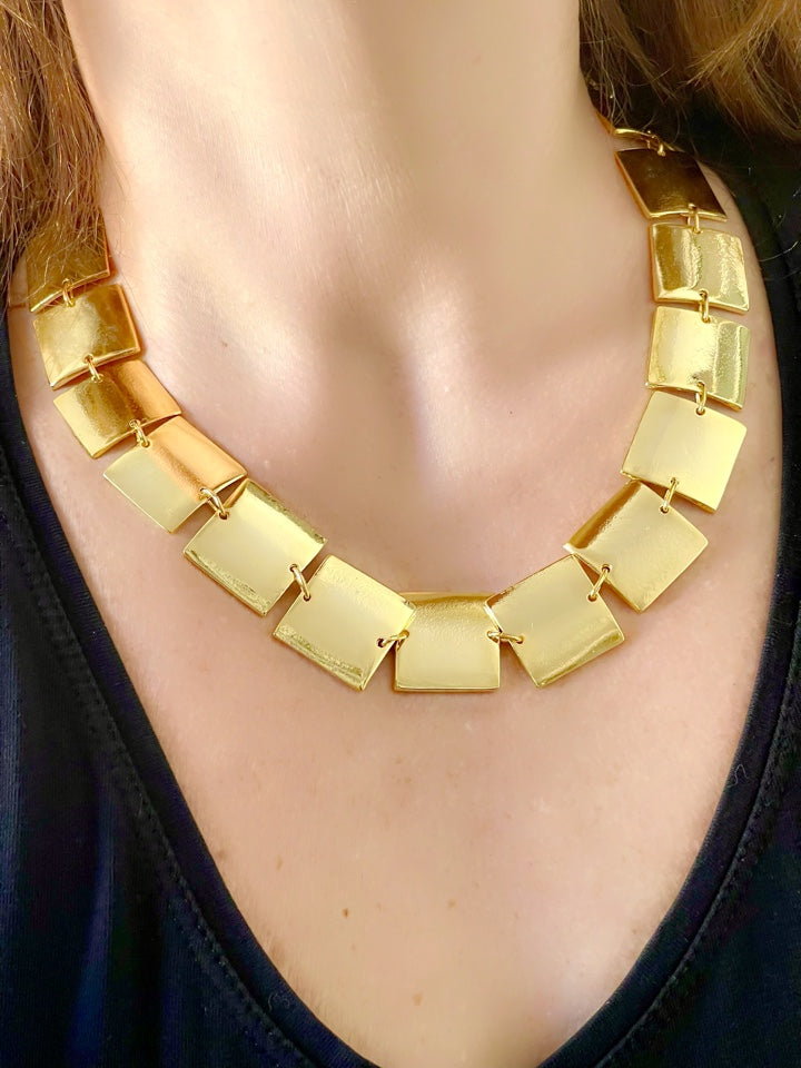 Close up of Iconic necklace of Paco Rabanne vintage gold plated jewelry set , bracelet- necklace refurbished 18KG worn on model