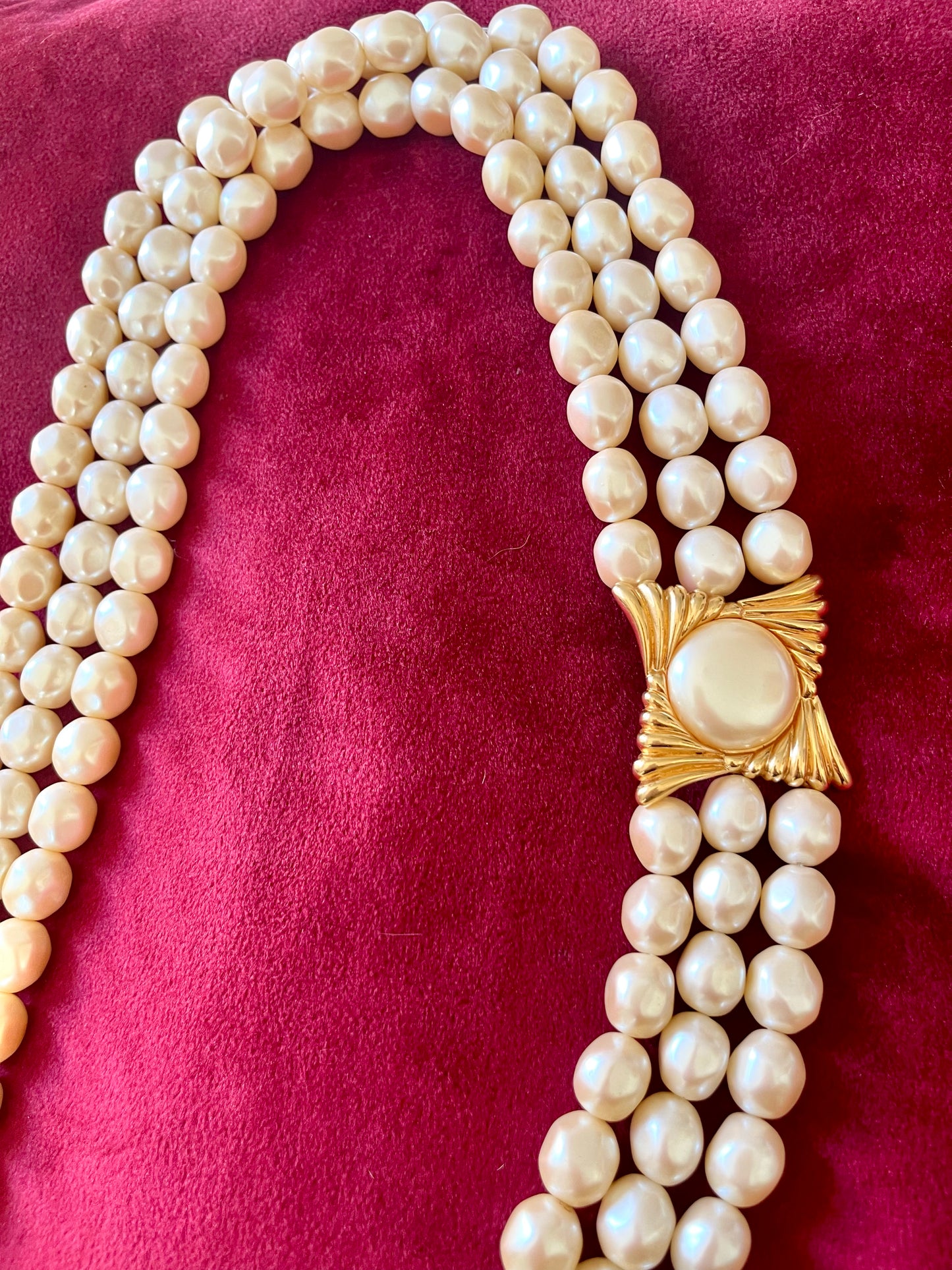 Vintage Yves Saint Laurent faux pearl statement necklace worn on model, showcasing multi-strand design and bold gold clasp at the neckline.