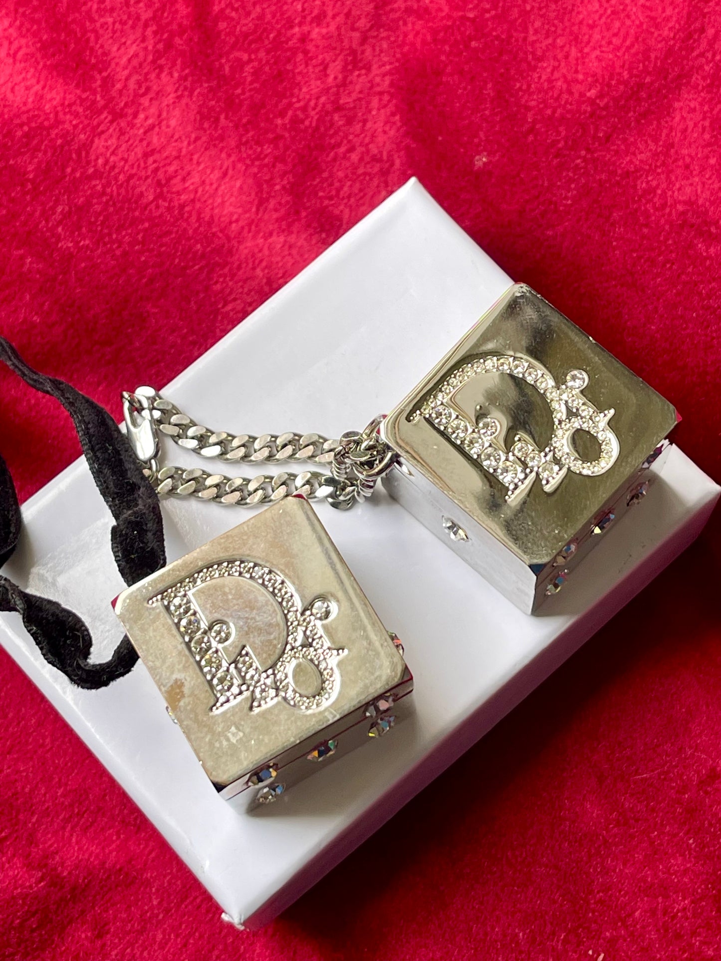 Front view of vintage Dior Play dice-shaped bag charm with silver finish and embedded crystals
