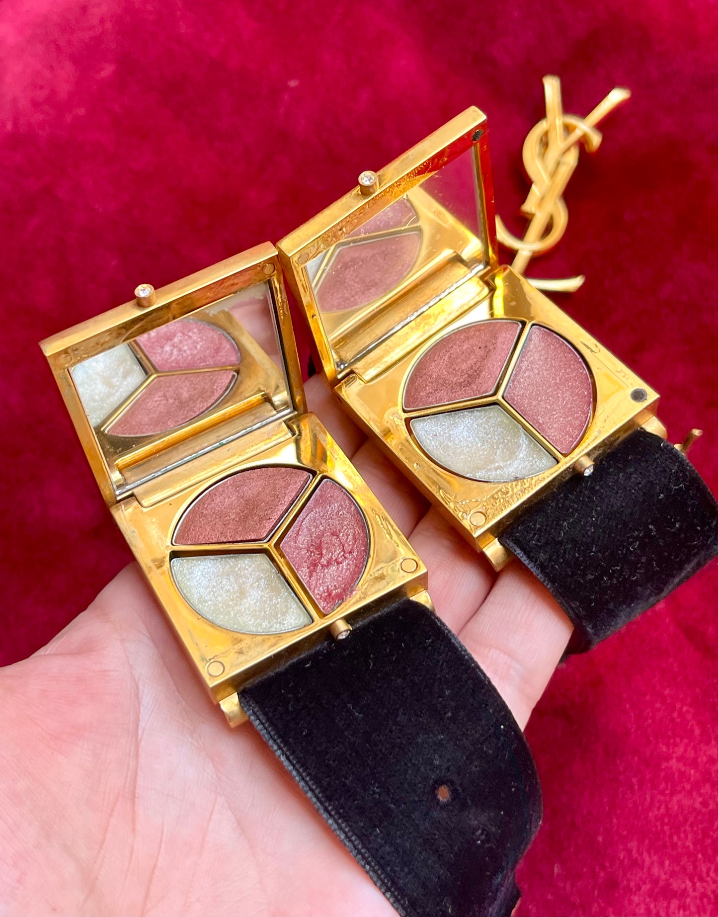 Inside view of mirror and makeup Fashion Bracelet makeup Yves Saint Laurent vintage 2000 on a red velvet background