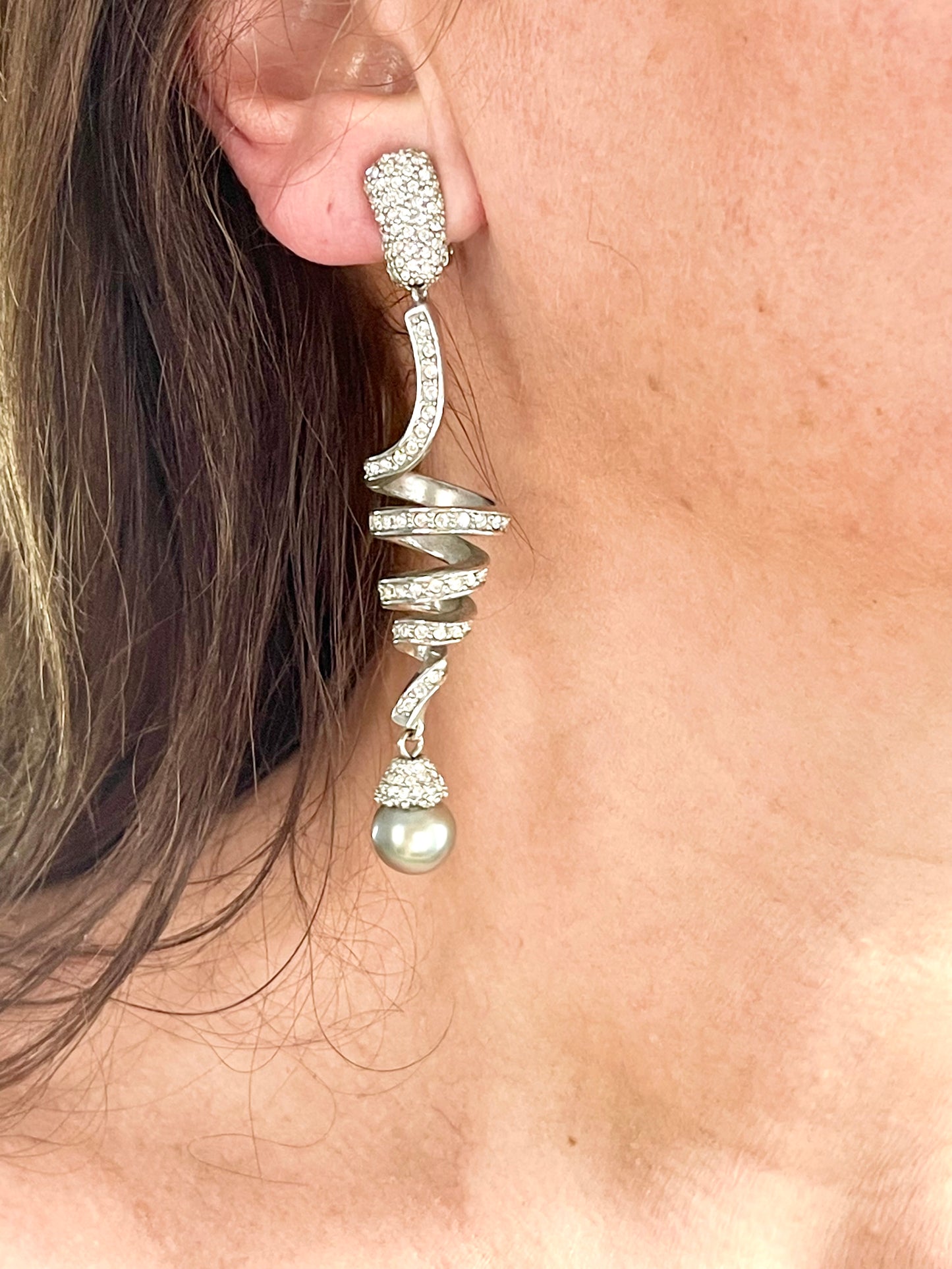 Close up look Grossé earrings worn, showcasing elegant drop design and pearl detail