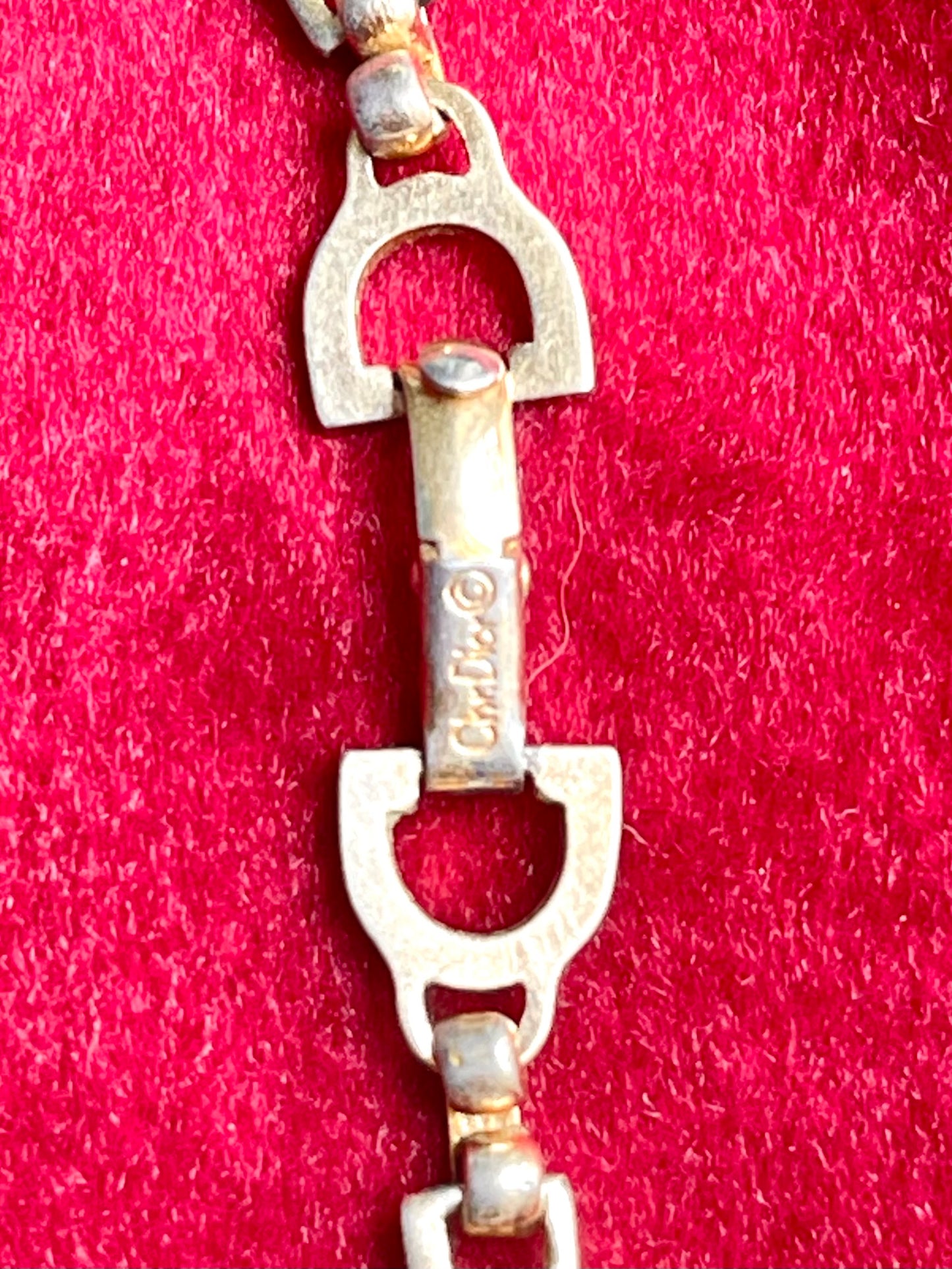 Authentic Vintage 80’s Christian Dior two-tone necklace with ribbed accents displayed on a red velvet background