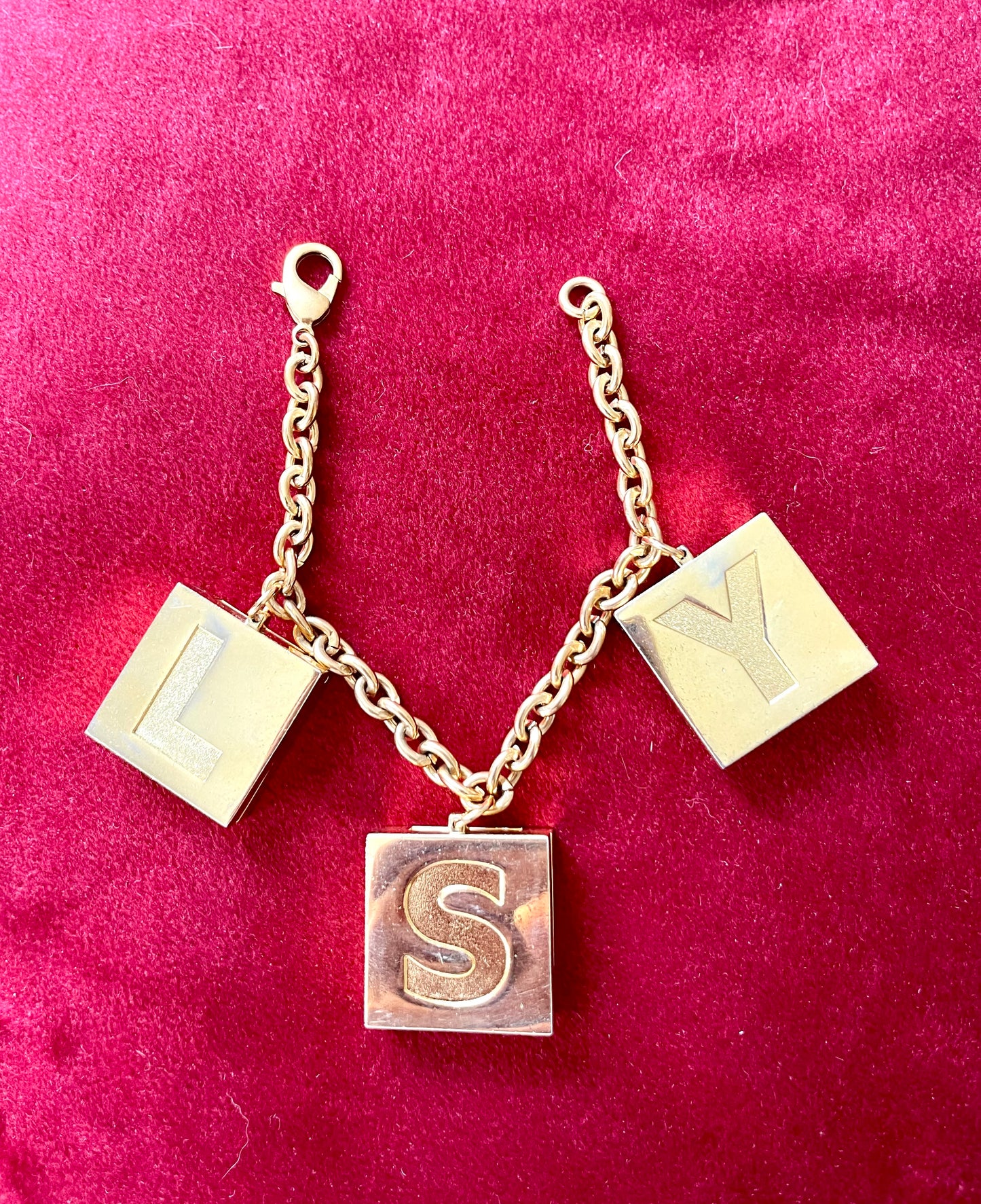 Front view YSL Yves Saint Laurent vintage 2000 makeup bracelet very good condition on red velvet background