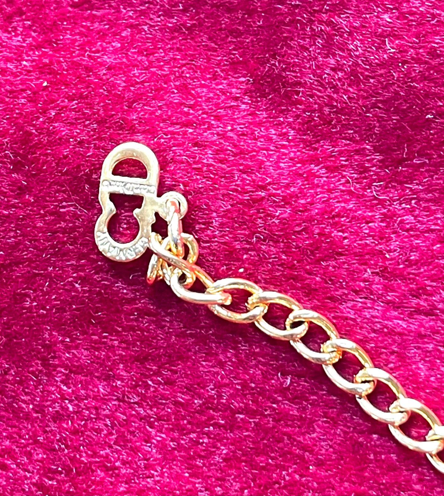 Close-up of Christian Dior CD logo charm on vintage 18K gold-plated necklace