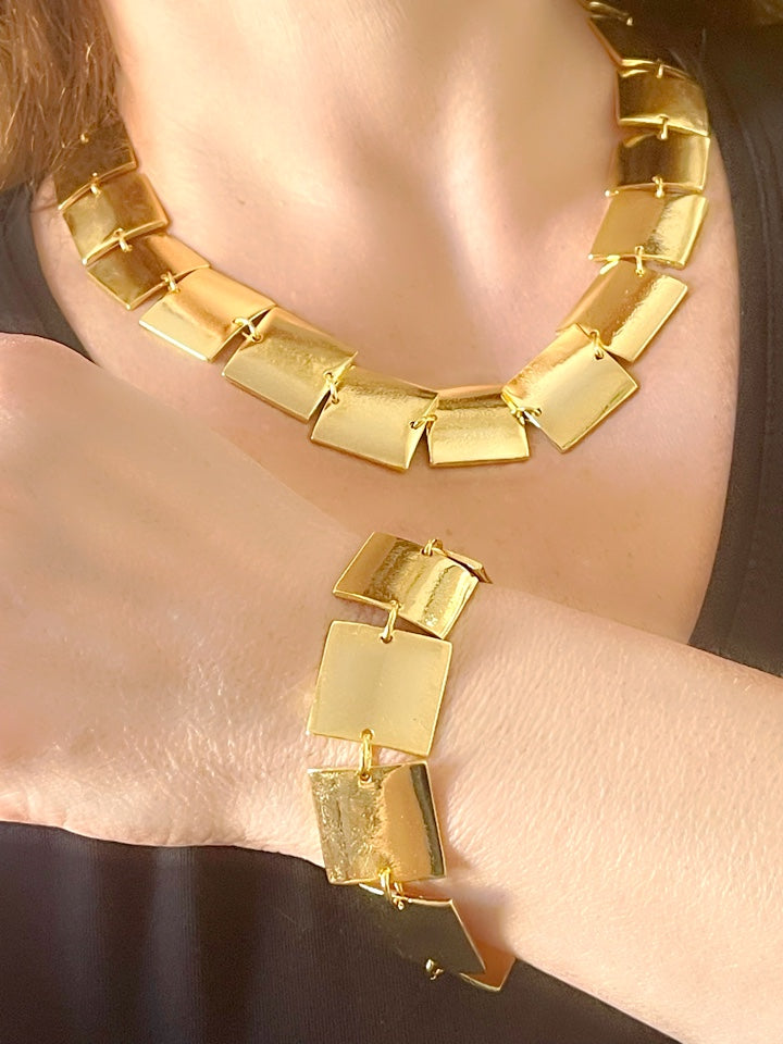Close up of Iconic Paco Rabanne vintage gold plated jewelry set , bracelet- necklace refurbished 18KG worn on model