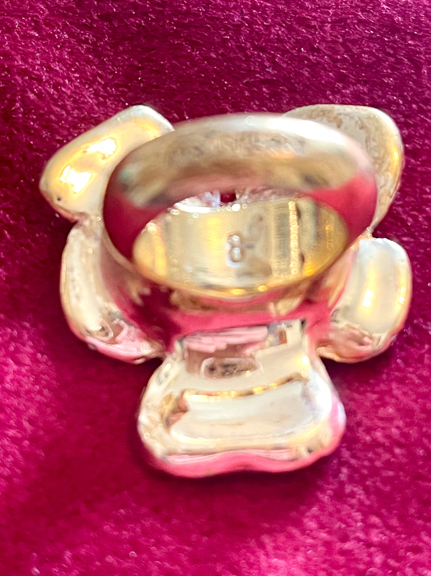 Close-up on size engraving of YSL gold-tone flower ring with rhinestones and pink enamel detail