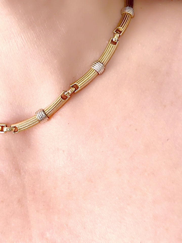 Vintage Christian Dior two-tone necklace worn around the neck, showcasing its elegant designer style from each side very good condition