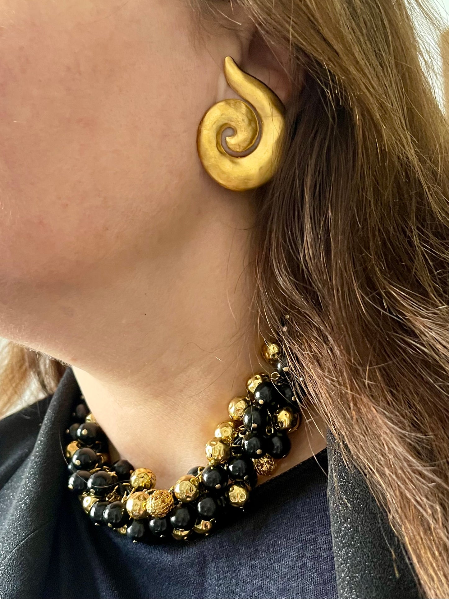 YSL earrings clip on with Vintage Yves Saint Laurent beaded necklace with black and gold beads, woven into braided black cotton cords, displayed on model