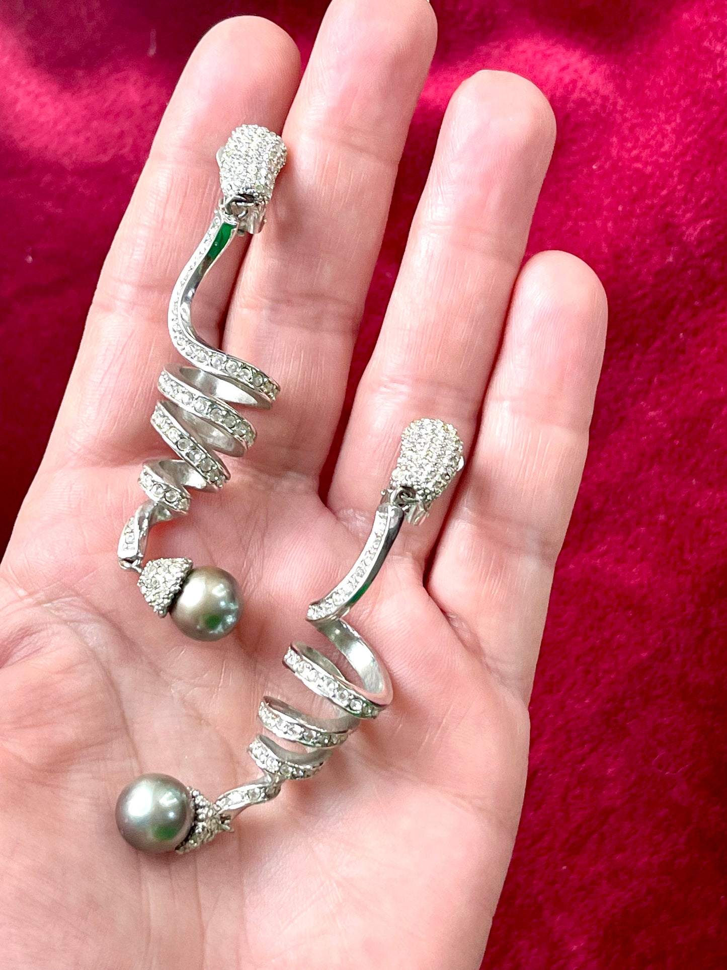 Side by side on hand showing Grossé earrings Dior elegant drop design and pearl detail