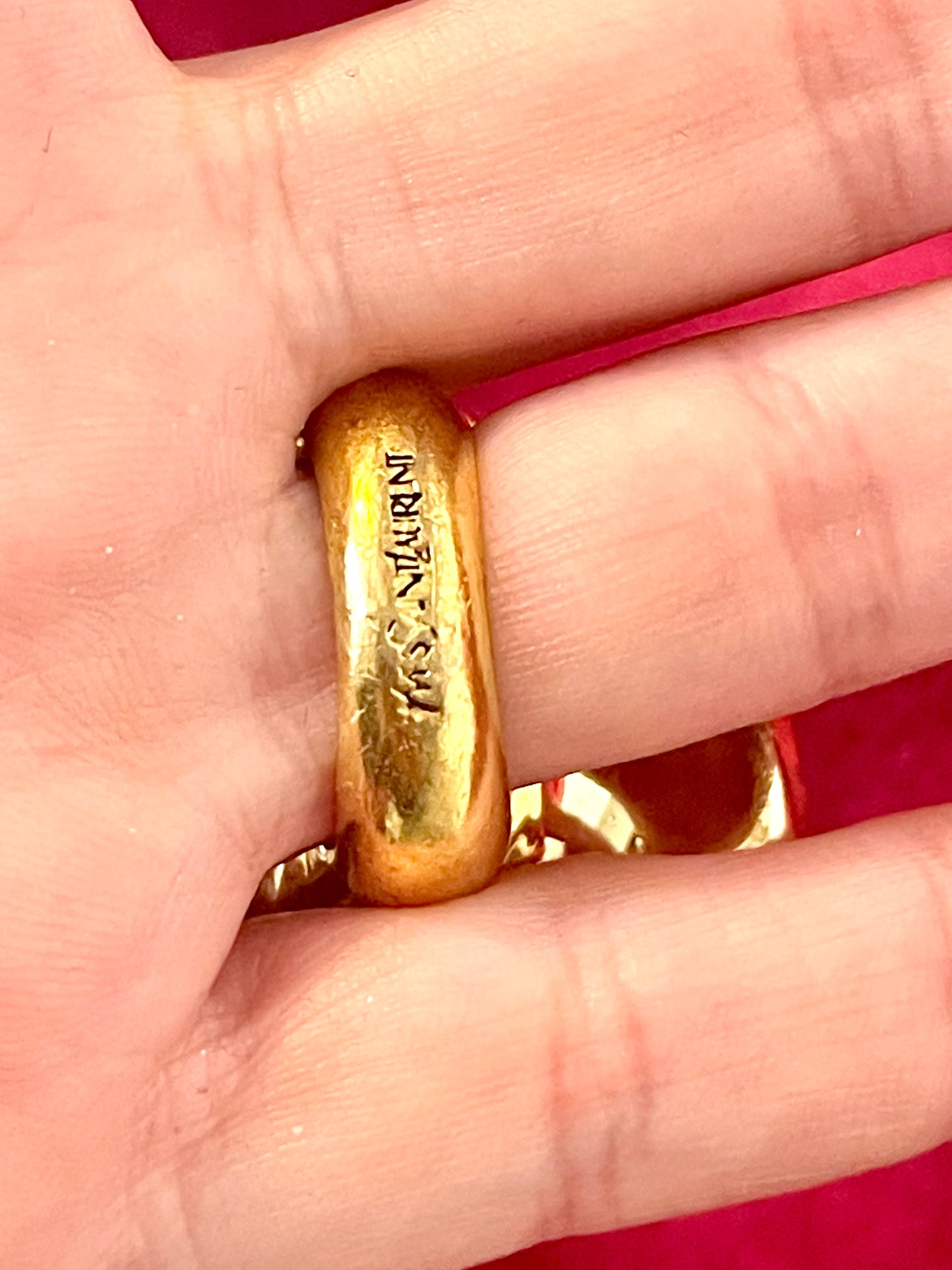 Close-up of Yves Saint Laurent authentic signs gold-tone flower ring with rhinestones and pink enamel detail