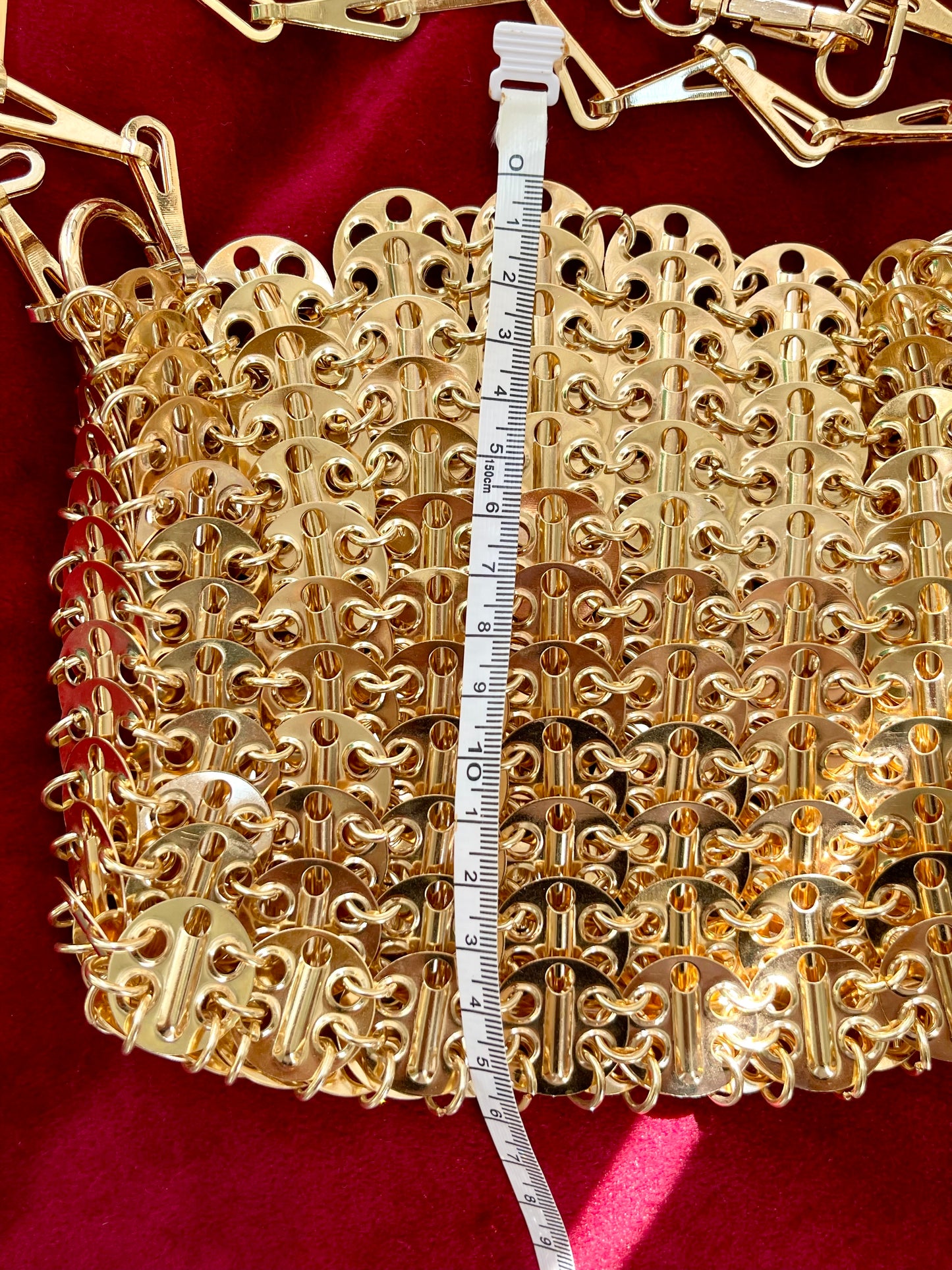 Rose gold dimensions sparkle 1969 design bag style Paco Rabanne using a measuring tape