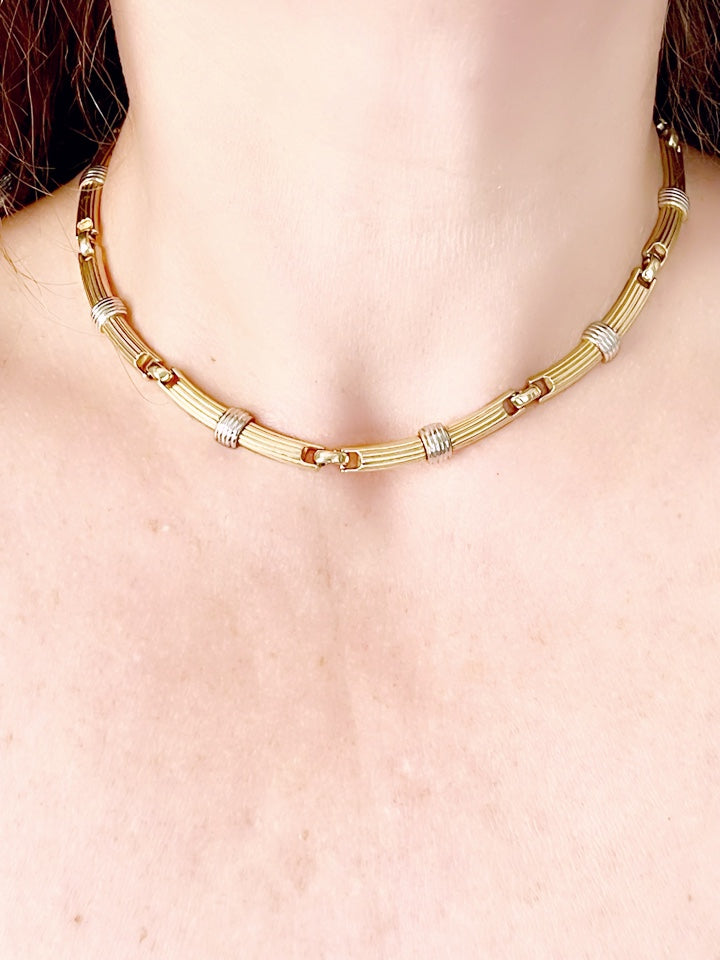 Vintage Christian Dior two-tone necklace worn around the neck, showcasing its elegant designer style