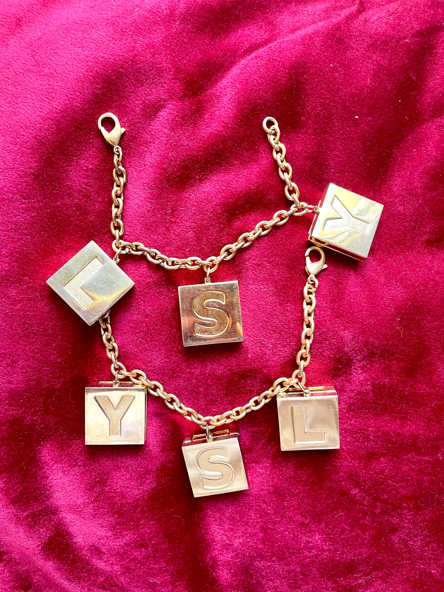 YSL Yves Saint Laurent vintage 2000 makeup bracelet very good condition on red velvet background