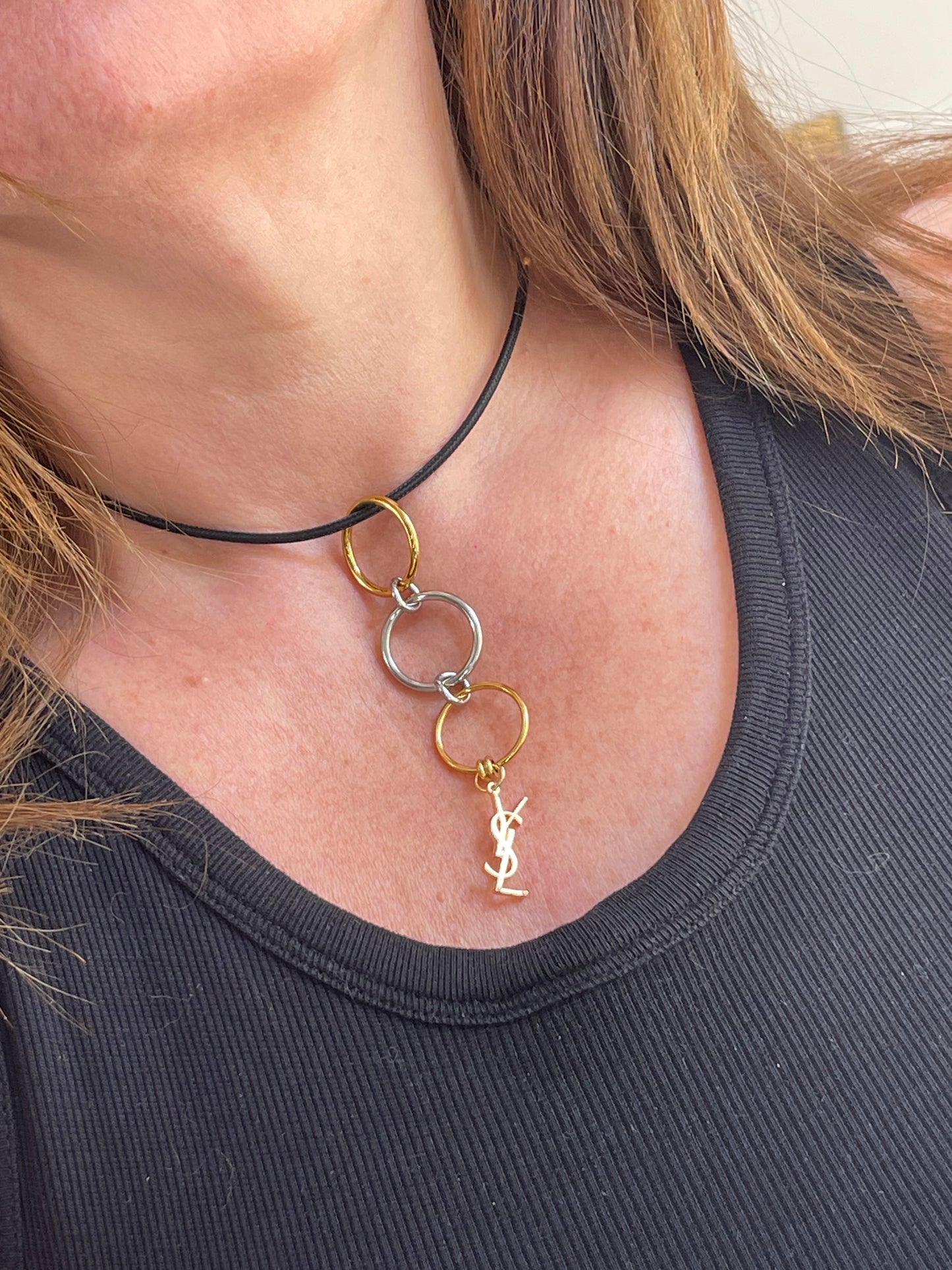 Worn as a pendant Yves Saint Laurent authentic charm as a ring pendant and bracelet with magnetic black cord