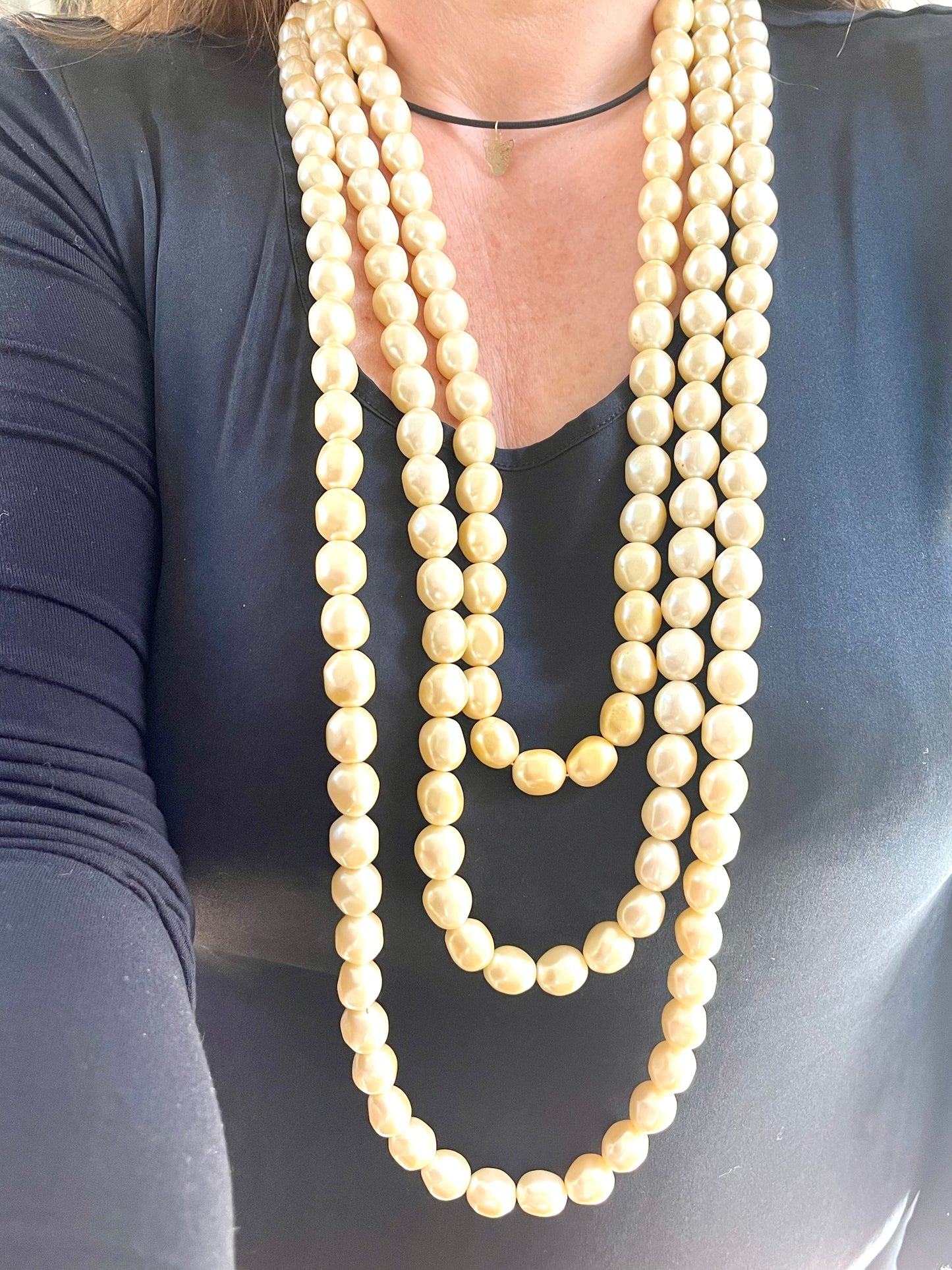 YSL vintage pearl necklace styled with classic outfit, adding elegant statement jewelry to a chic ensemble
