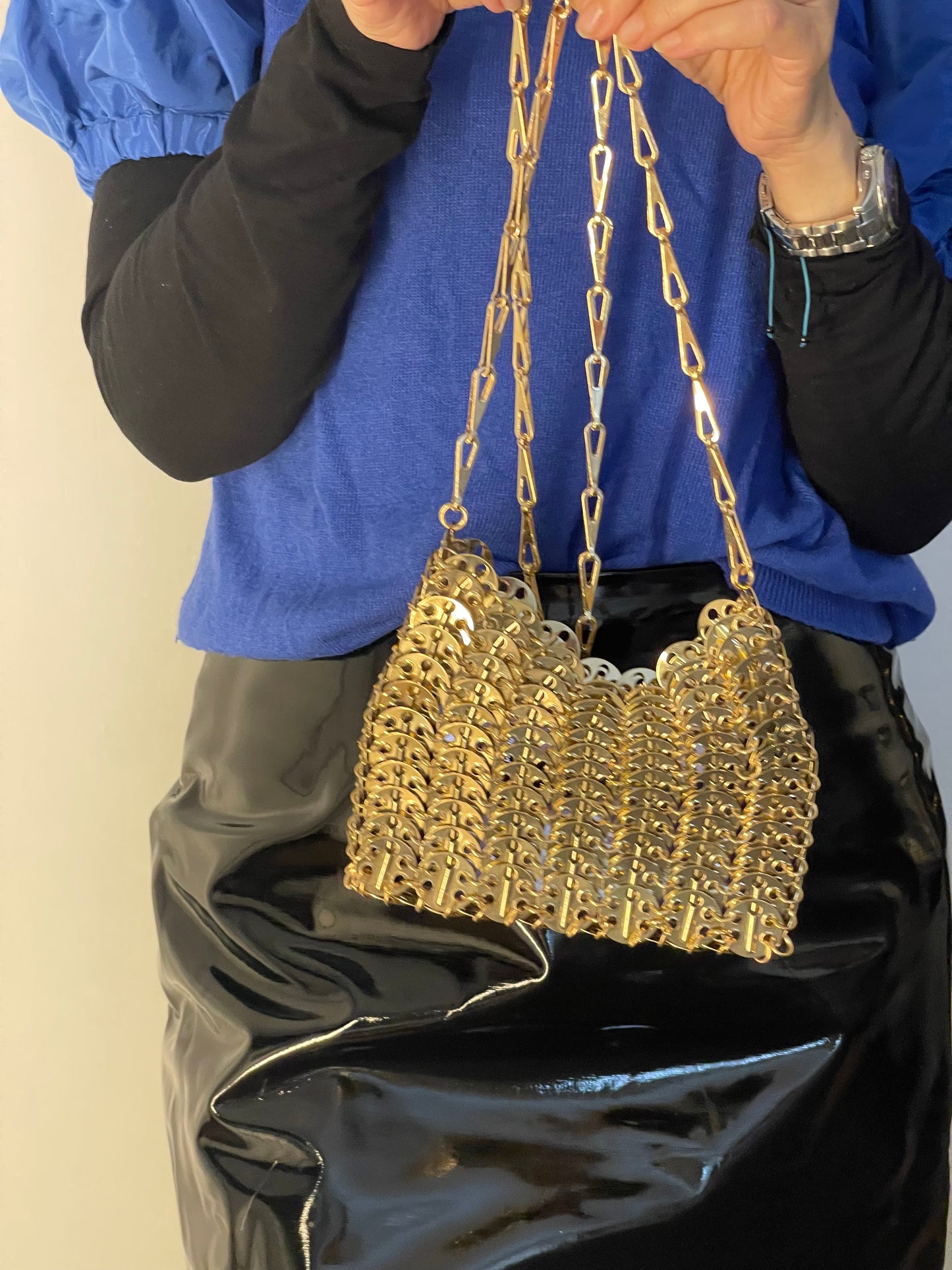 Held by model gold sparkle 1969 design bag style Paco Rabanne crossbody bag