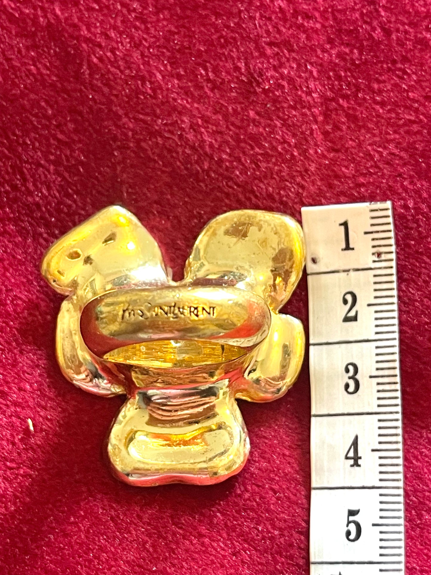 Close-up of Yves Saint Laurent gold-tone flower ring with rhinestones and pink enamel detail authentic signed