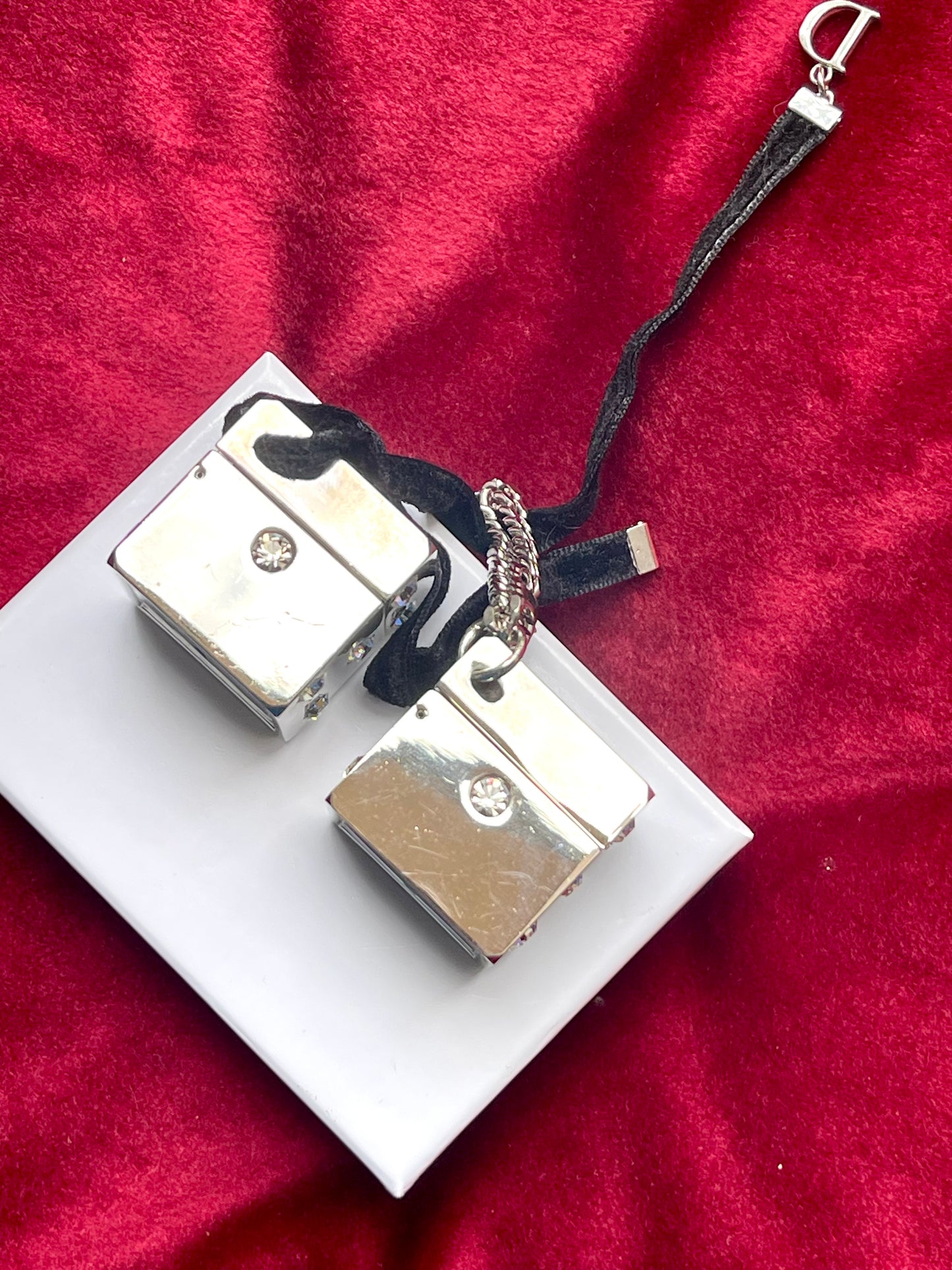 Side view of vintage Dior Play dice-shaped bag charm with silver finish and embedded crystals vintage collection 2000