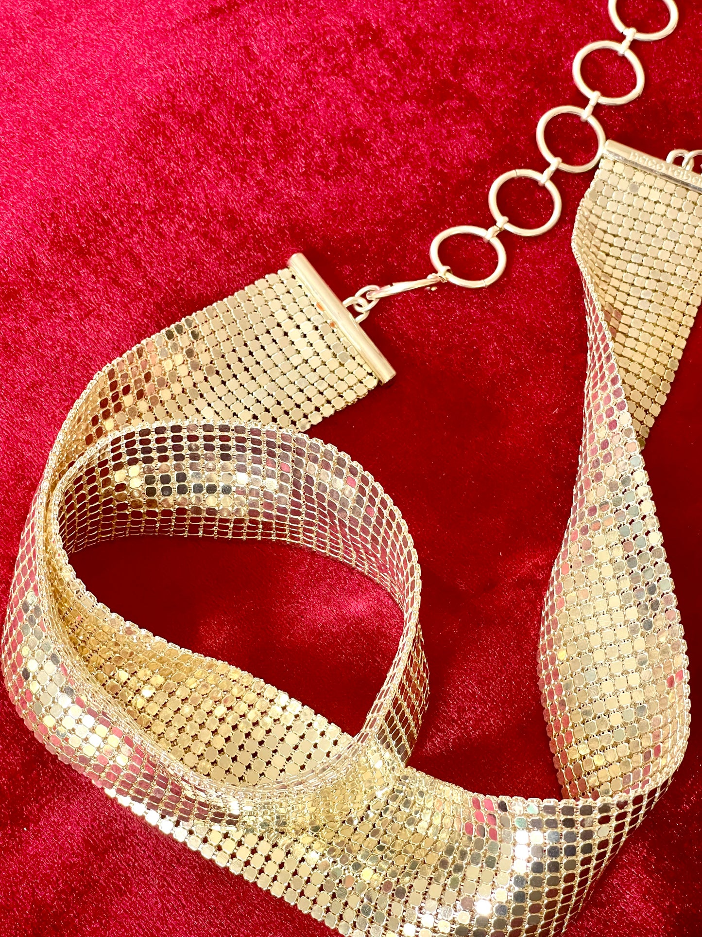 Close-up of pixel metal mesh texture reflecting light of Vintage Paco Rabanne belt