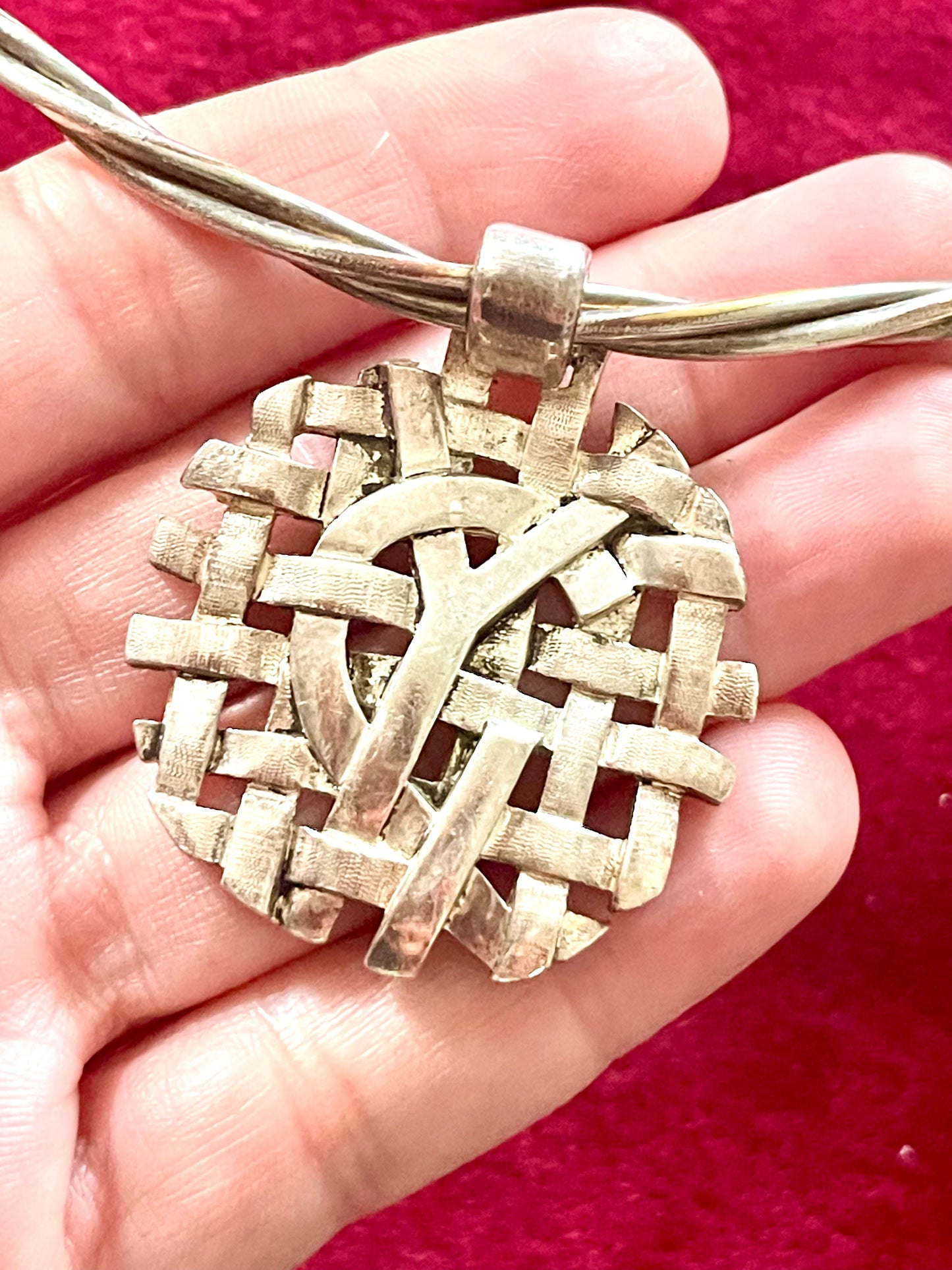 Close up on Yves Saint Laurent silver pendant monogram signed authentic vintage necklace chocker