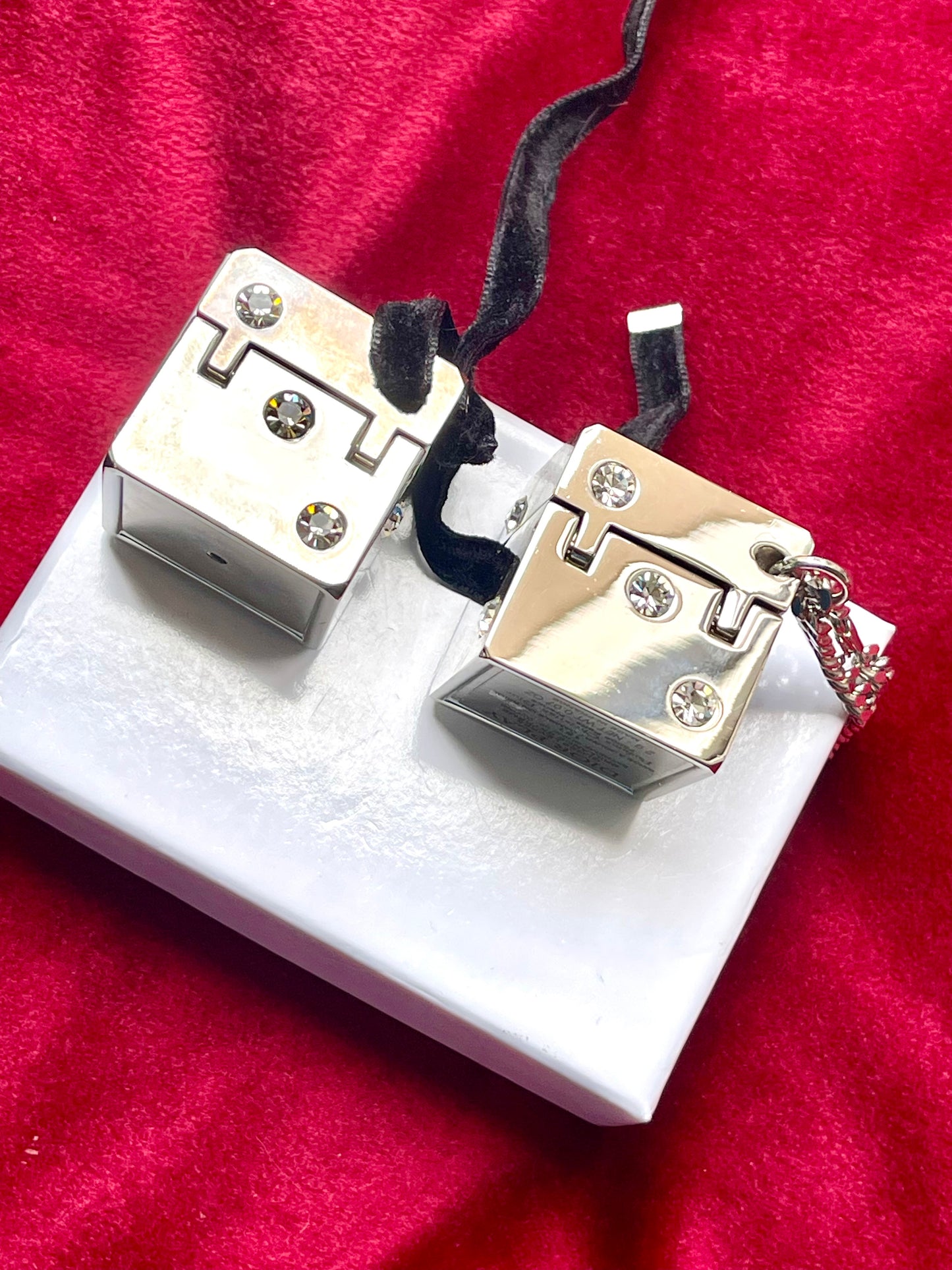 Side view of vintage Dior Play dice-shaped bag charm with silver finish and embedded crystals vintage collection 2000