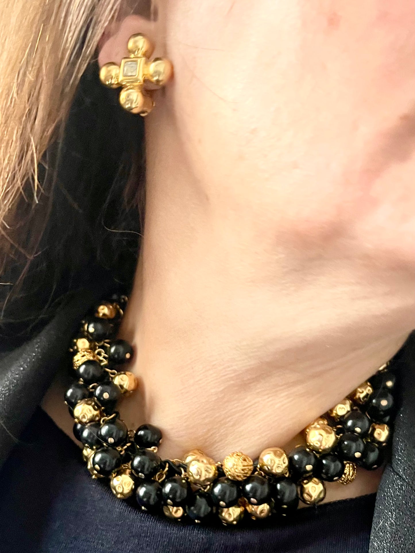 Close up worn by model YSL cross earrings combined with Vintage Yves Saint Laurent beaded necklace with black and gold beads, woven into braided black cotton cords,