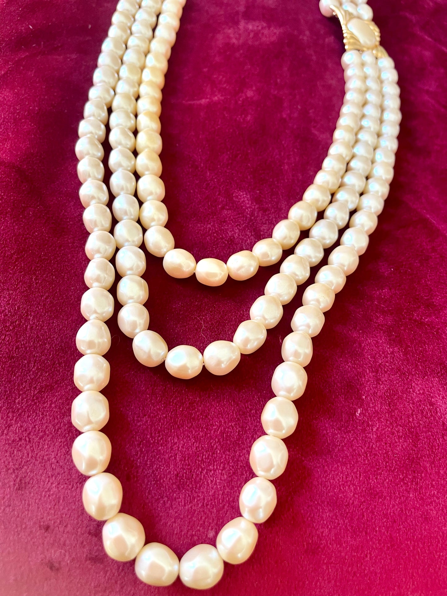 Vintage Yves Saint Laurent faux pearl statement necklace , showcasing multi-strand design and bold gold clasp at the neckline.