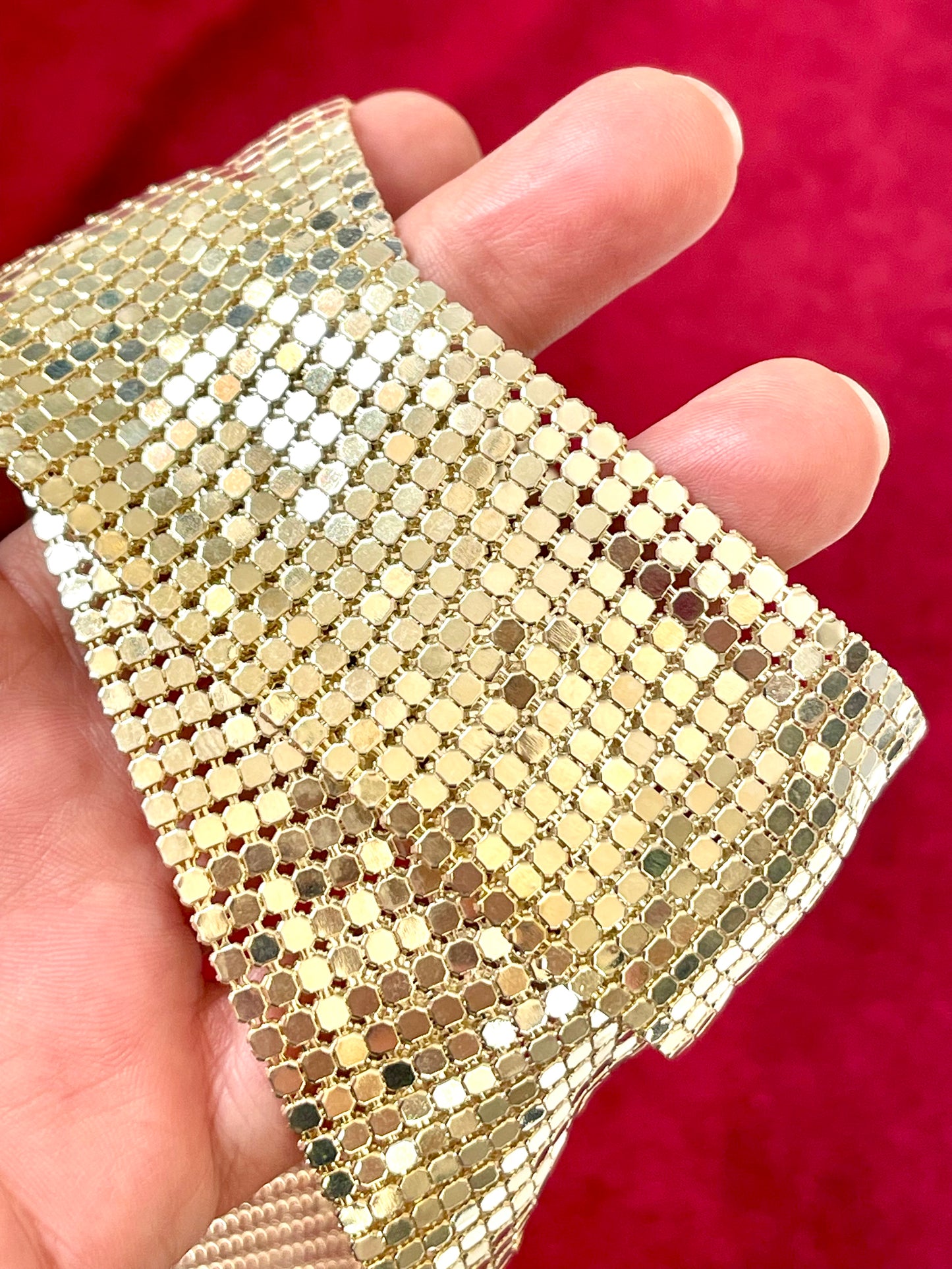 Close-up of pixel metal mesh texture reflecting light of Vintage Paco Rabanne belt