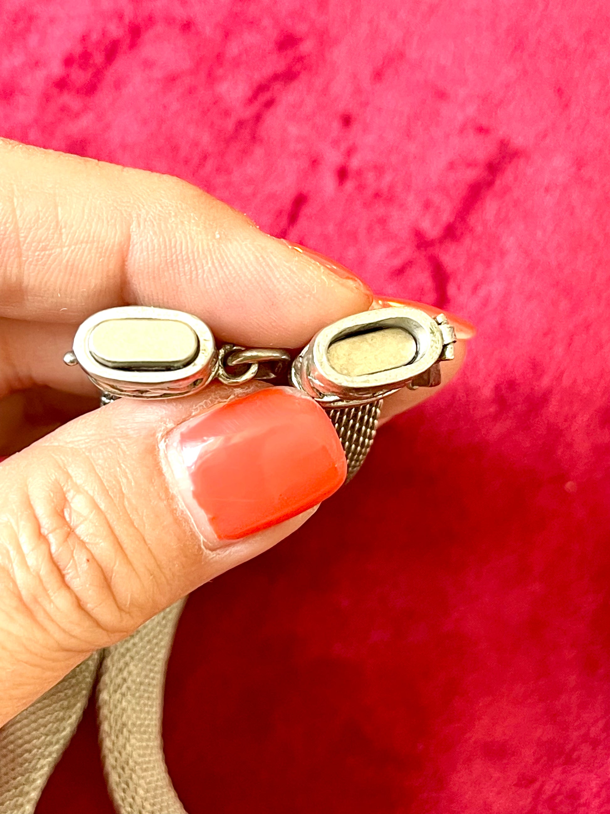 Close up on magnetic closure Monet Yves Saint Laurent silver metal necklace rhinestone tagged chocker