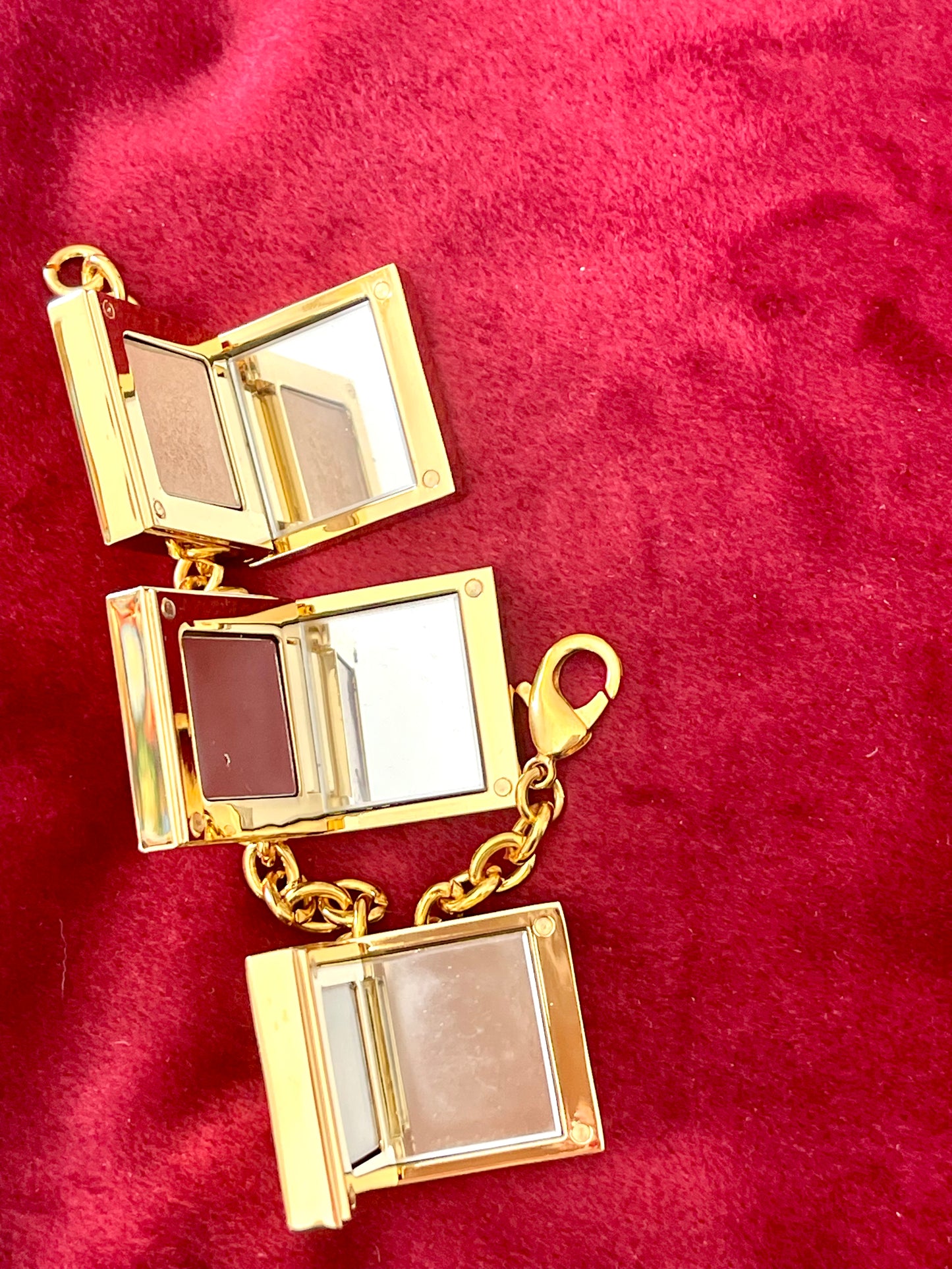 Close up on inside of YSL Yves Saint Laurent vintage 2000 makeup bracelet very good condition on red velvet background