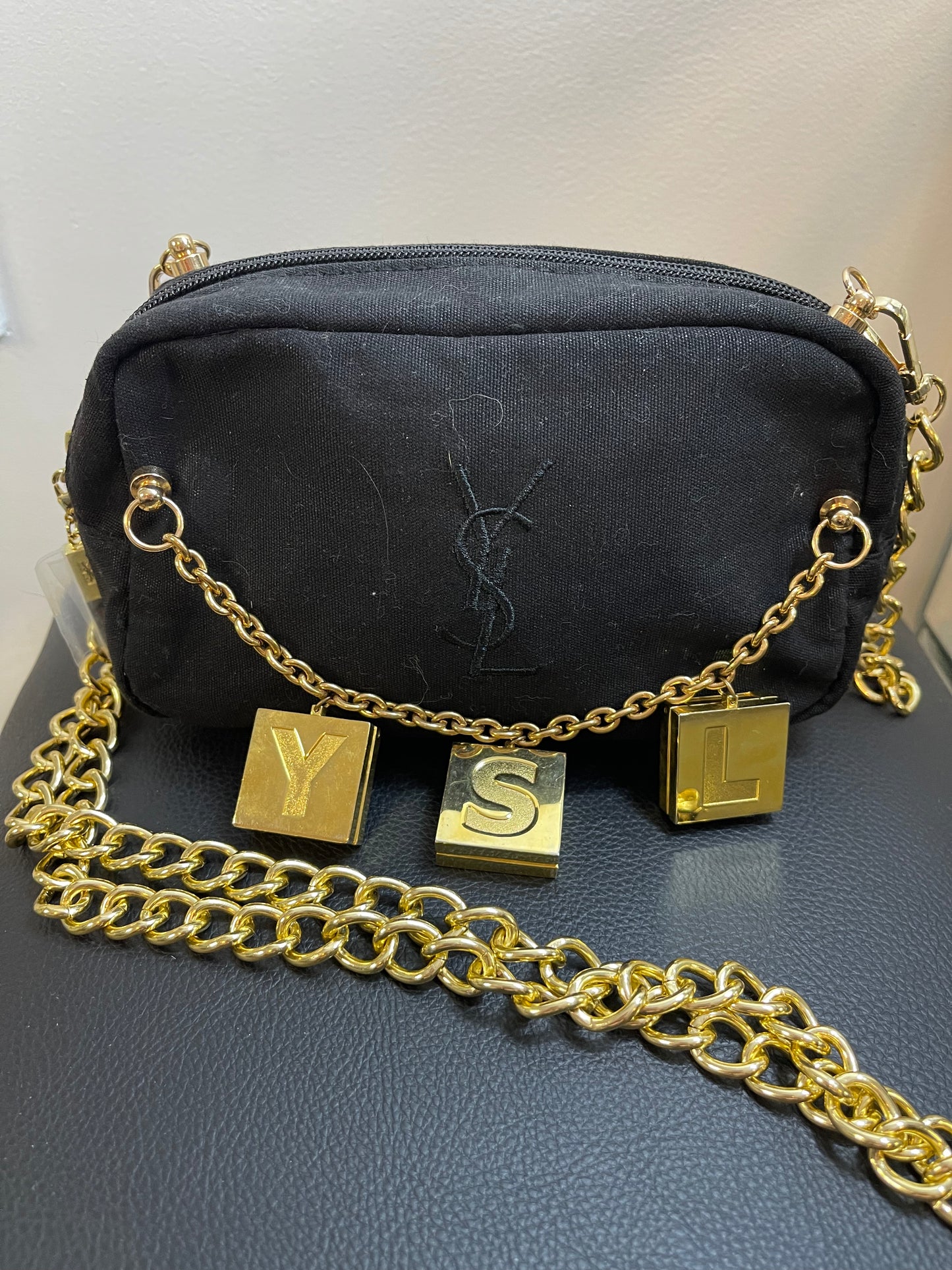 Alternative design shown on bag as bag charm YSL Yves Saint Laurent vintage 2000 makeup bracelet very good condition on red velvet background