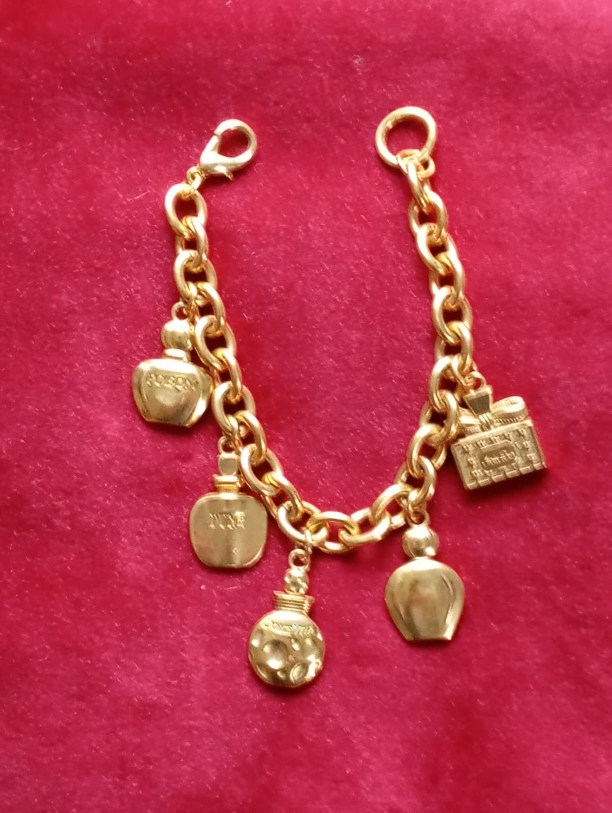 Close-up of Dior perfume bottle charms referencing Miss Dior, Poison, and Dolce Vita