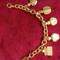 Vintage Dior bracelet on red background showing all charms