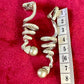 Measurement of a Pair of Dior Grossé rhinestone and pearl drop earrings placed side by side on red background