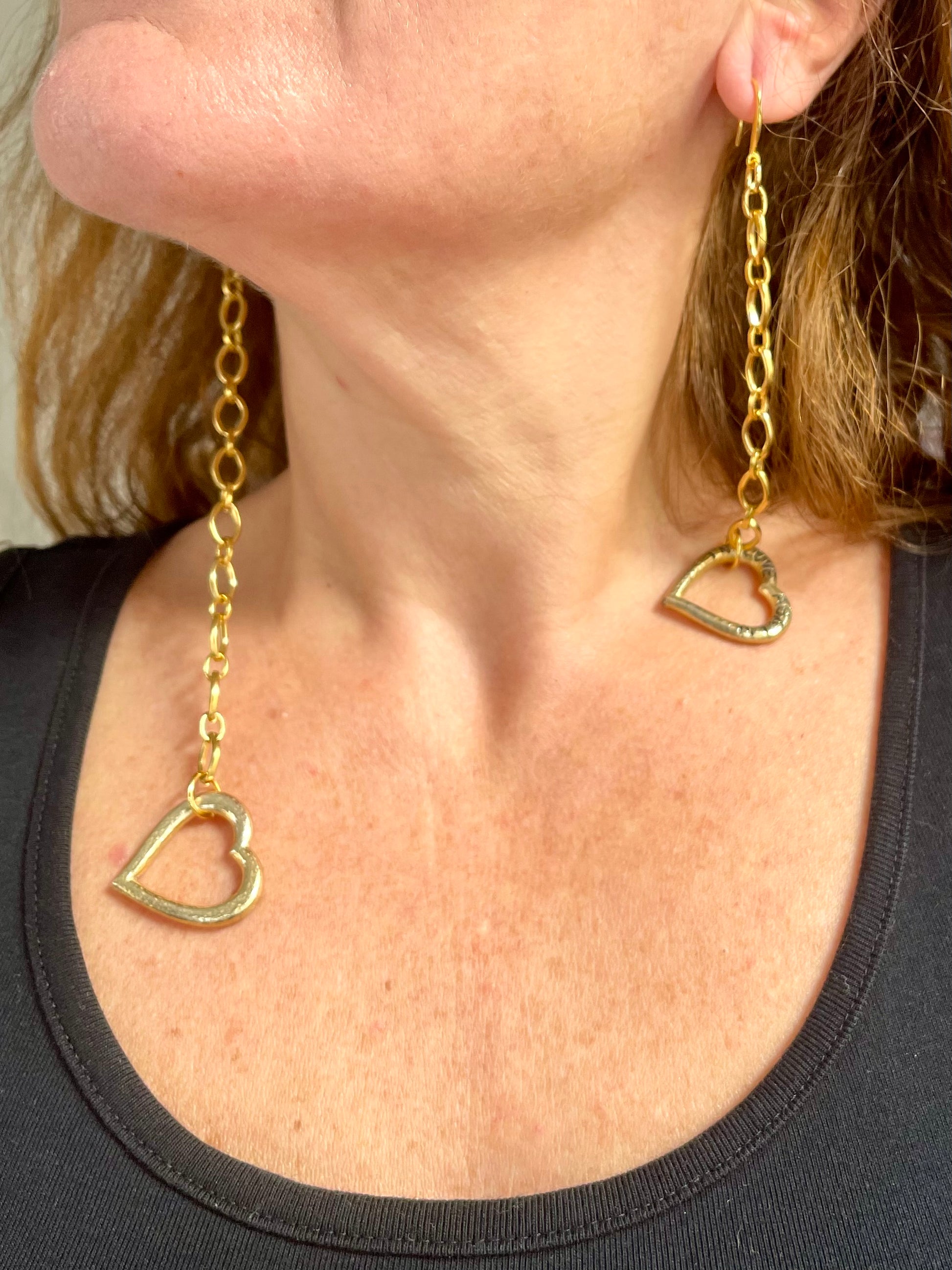 Dangling gold-plated YSL earrings, elegant asymmetrical design Worn by model 