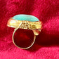 Side profile of a vintage YSL ring showing the intricate textured gold band and raised turquoise nacre centerpiece.authentic signed Yves Saint Laurent 