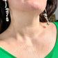 Grossé Dior earrings worn, showcasing elegant drop design and pearl detail