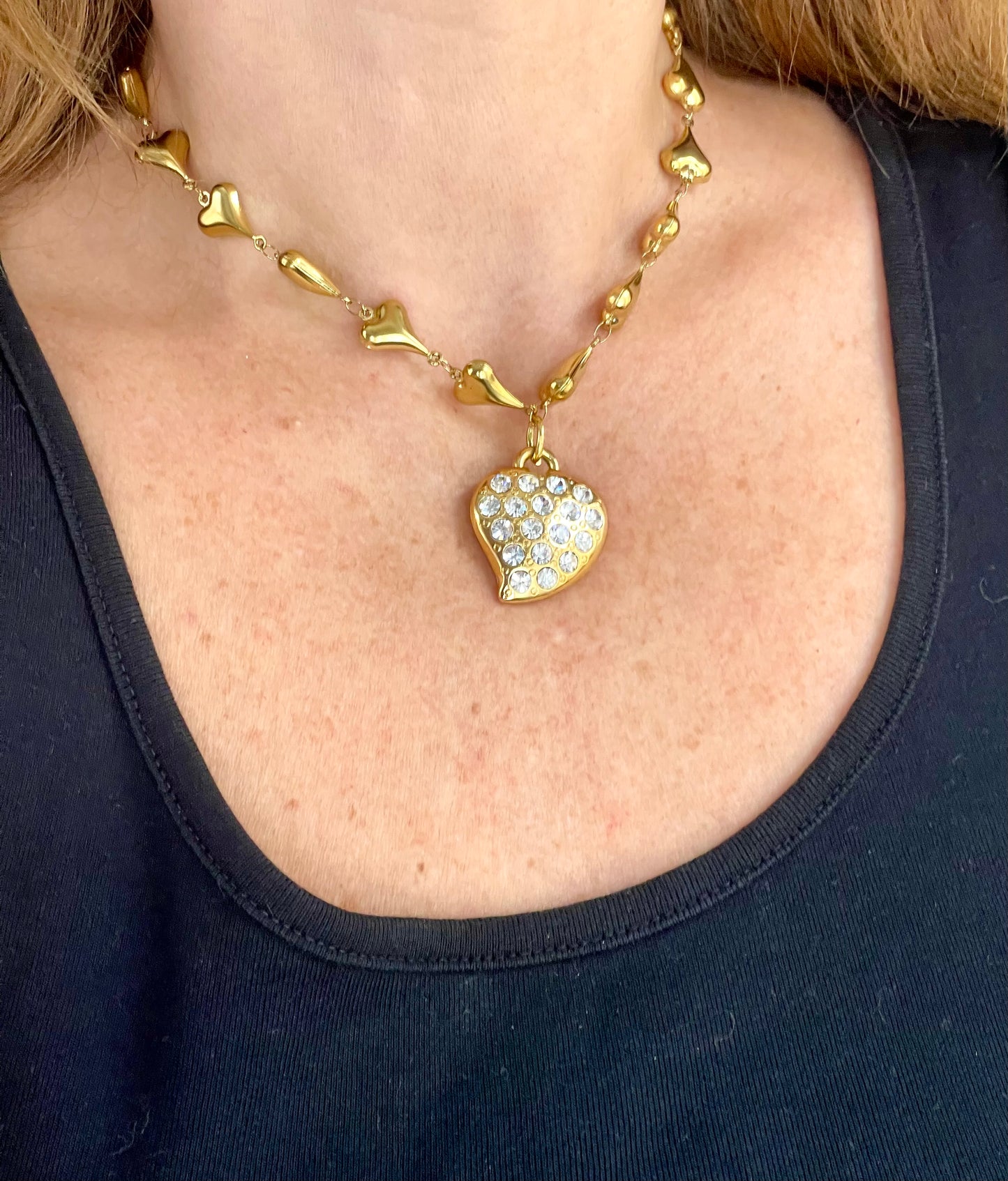 Vintage Yves Saint Laurent heart rhinestone pendant necklace with gold stainless steel chain worn by model